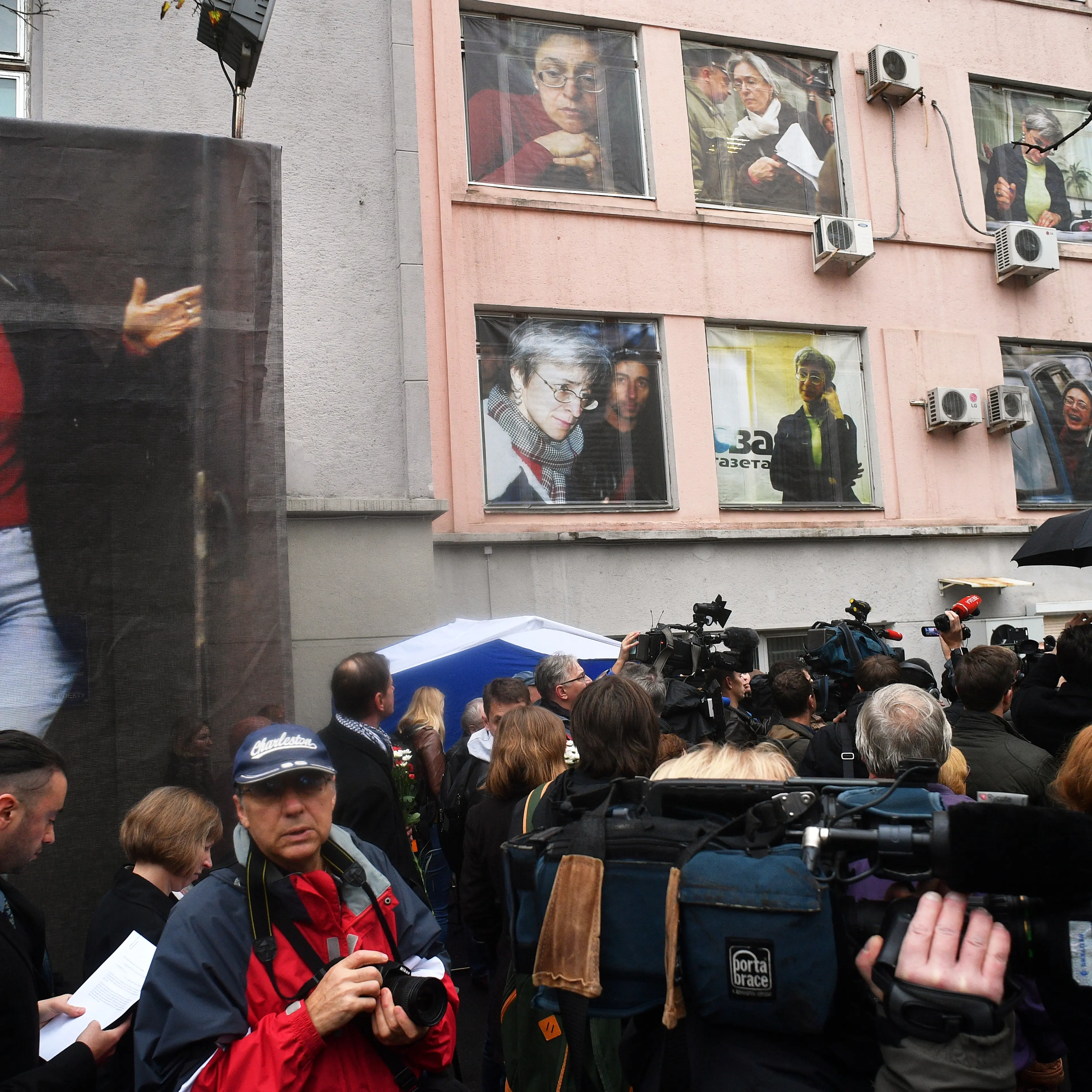 Ten giant portraits are posted on the windows of the Novaya Gazeta editorial office during a commemorative event marking the 10th anniversary of journalist Anna Politkovskaya death, Oct. 7, 2016.