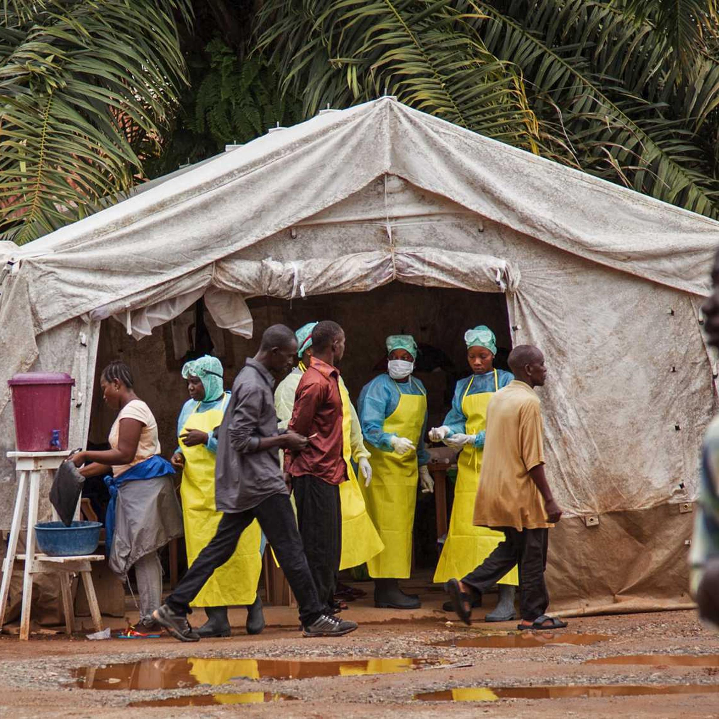 Health workers screen people for the deadly Ebola virus before entering the Kenema Government Hospital in Kenema, 300 kilometers, (186 miles) from the capital city of Freetown, Sierra Leone on August 9, 2014.