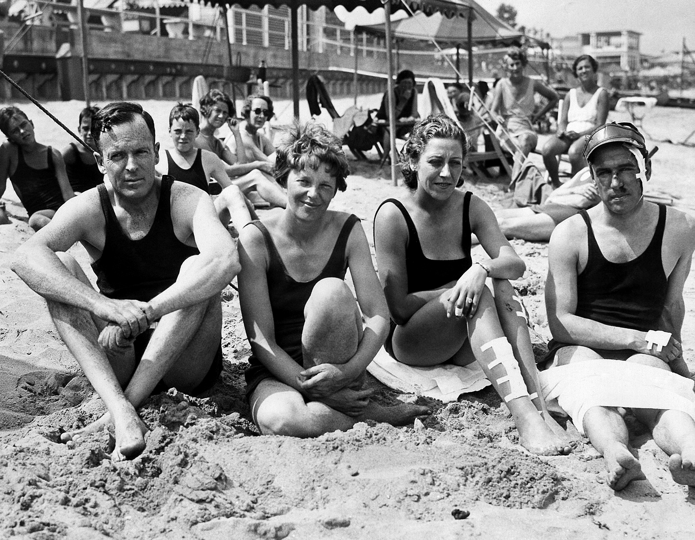 Amelia Earhart and her husband George Palmer Putnam with friends Capt. and Mrs. J.A. Mollison on the sand in Rye, New York, July 29, 1933.