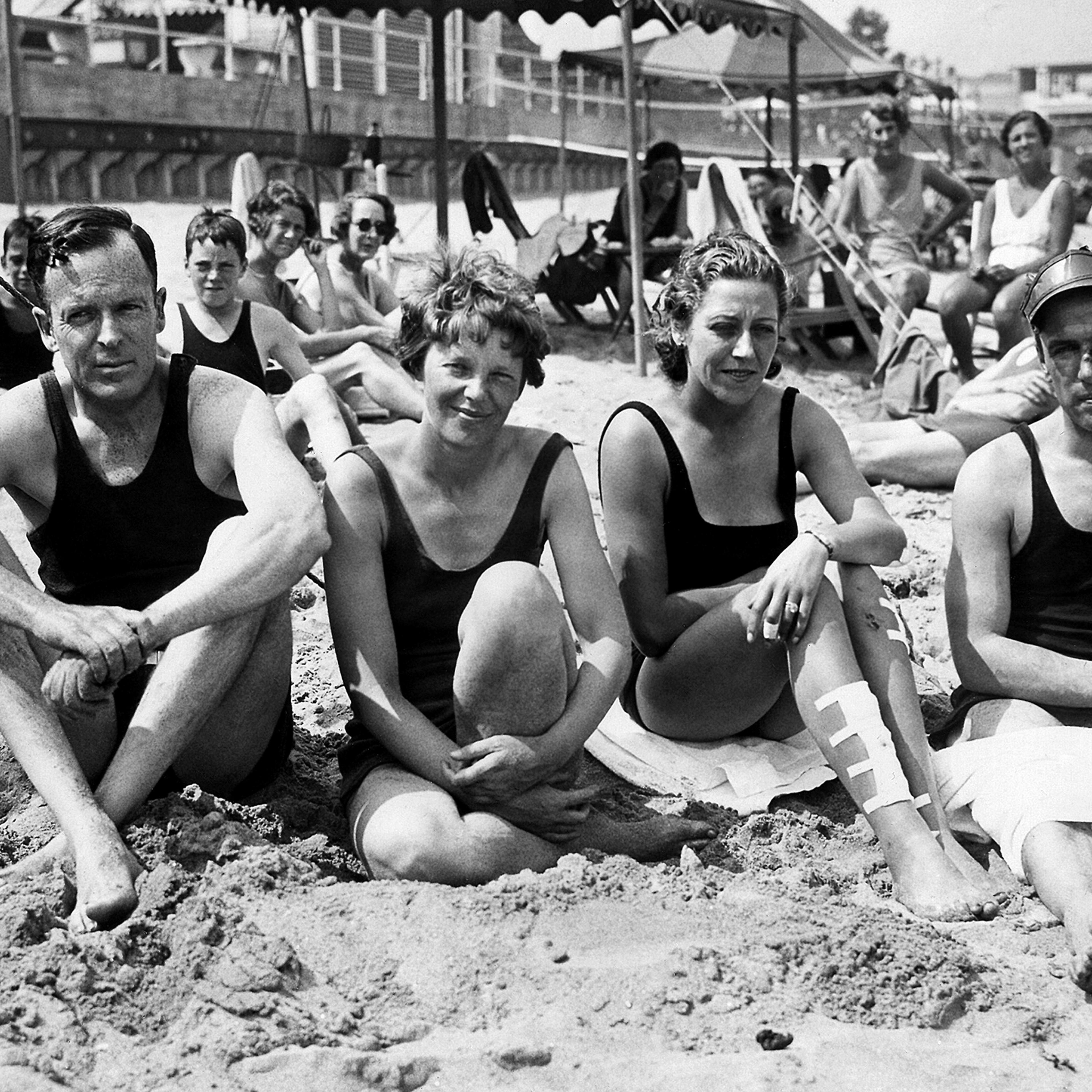 Amelia Earhart and her husband George Palmer Putnam with friends Capt. and Mrs. J.A. Mollison on the sand in Rye, New York, July 29, 1933.