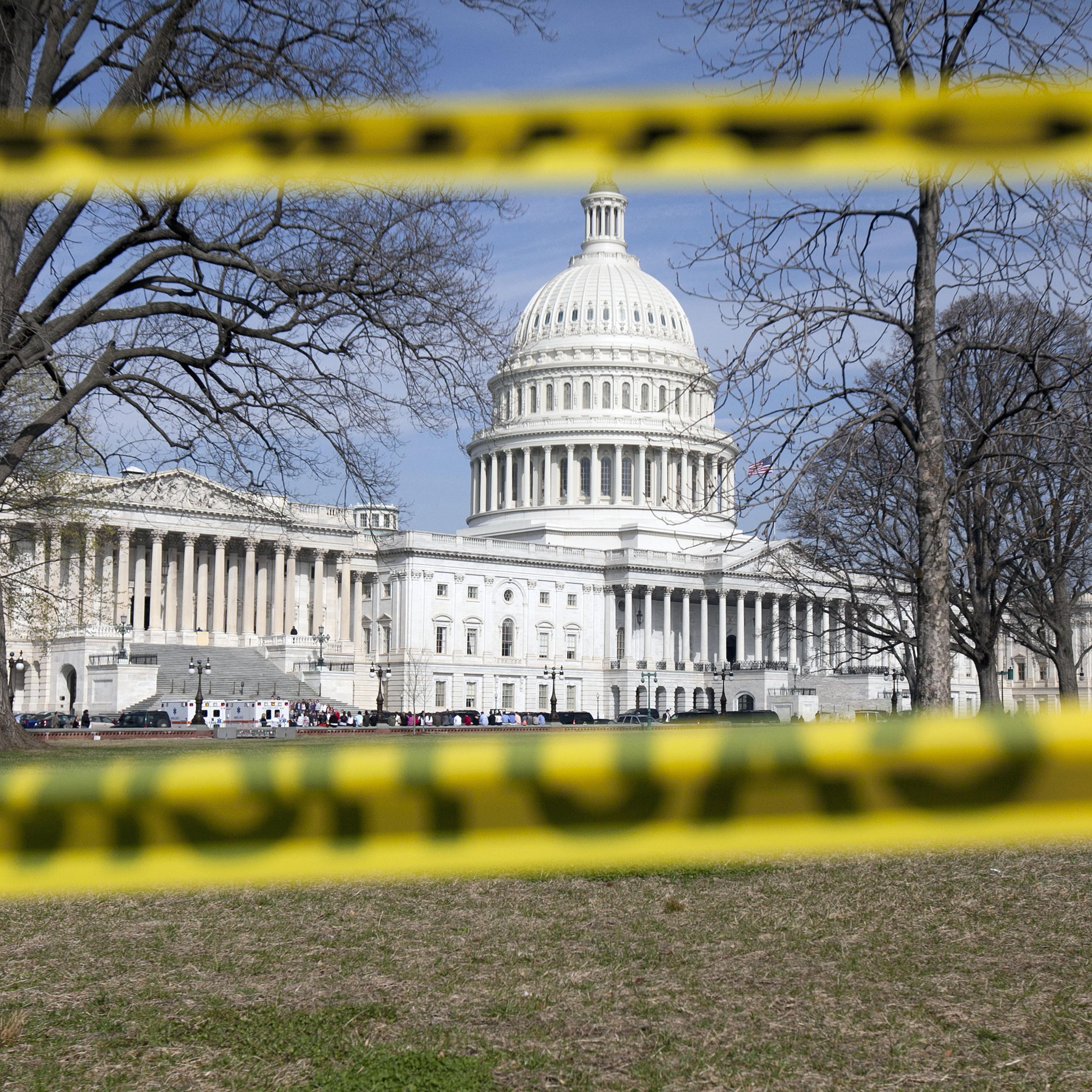 The Capitol building stands behind caution tape