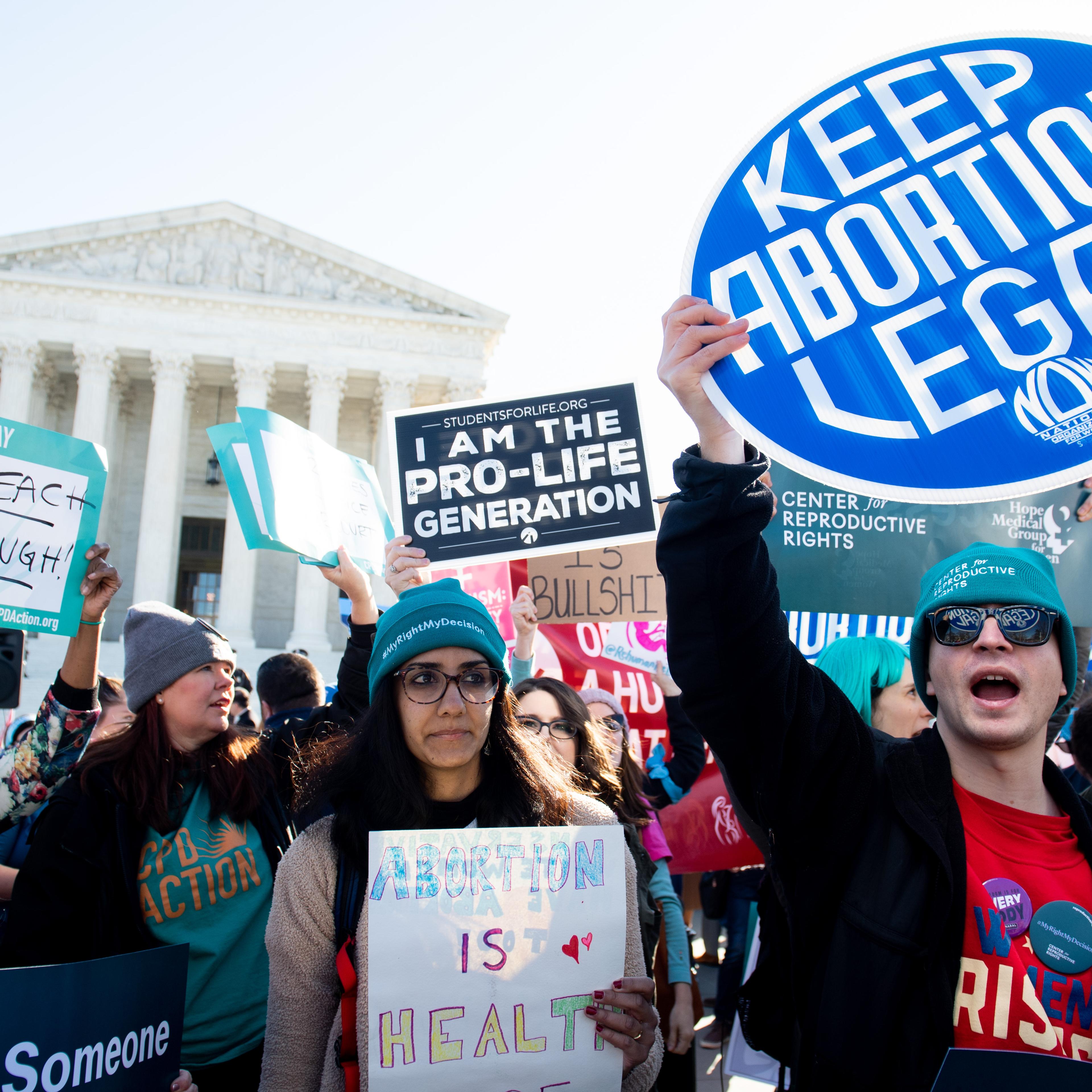 Abortion rights activists and those opposing abortion protest during a demonstration outside the U.S. Supreme Court in Washington, D.C., March 4, 2020, during oral arguments regarding a Louisiana law about abortion access.