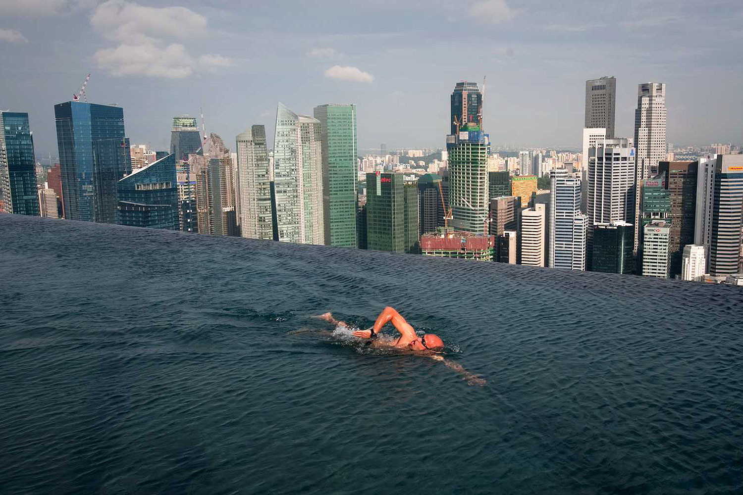 A guest swims in the infinity pool of the Skypark that tops the Marina Bay Sands hotel towers in Singapore June 24, 2010