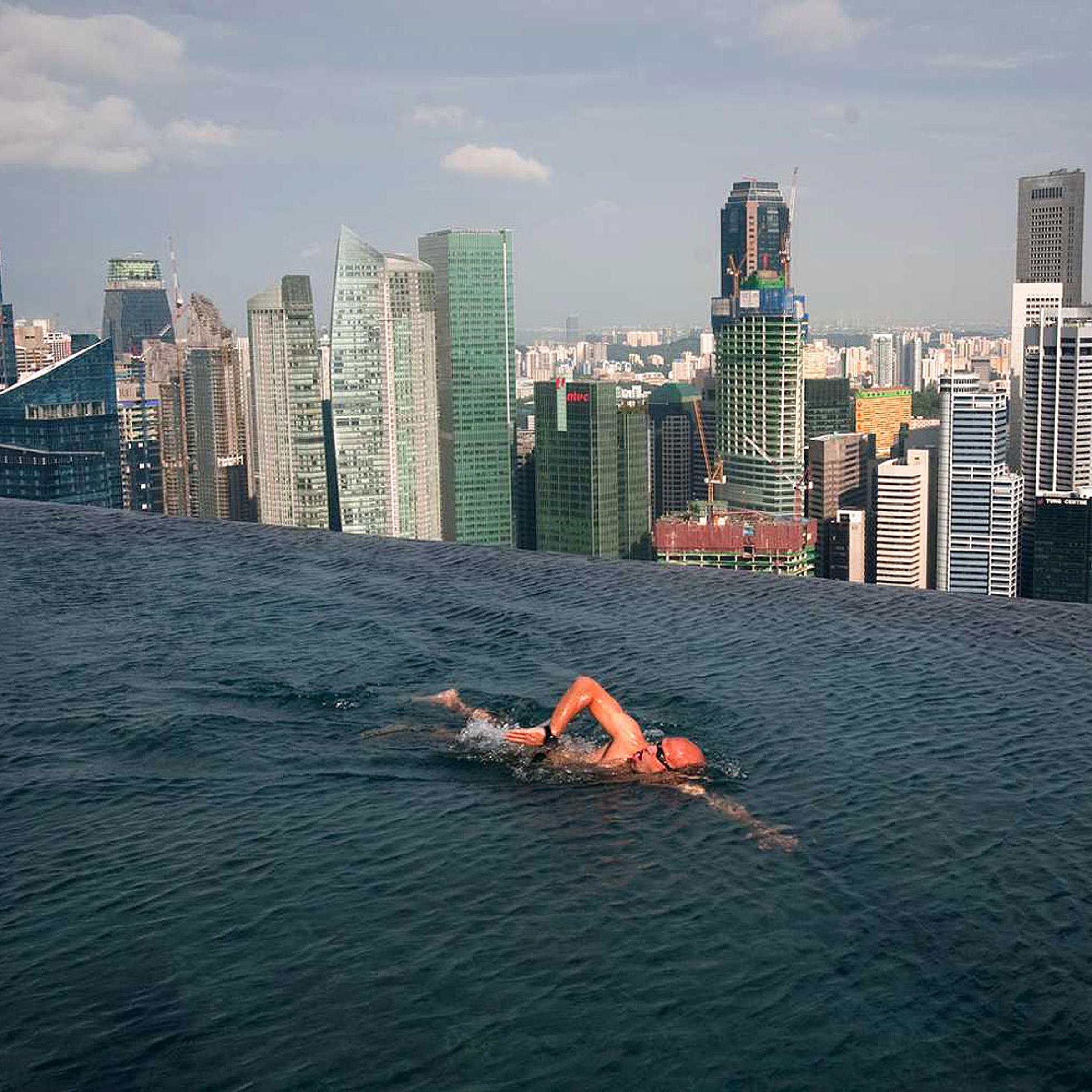 A guest swims in the infinity pool of the Skypark that tops the Marina Bay Sands hotel towers in Singapore June 24, 2010