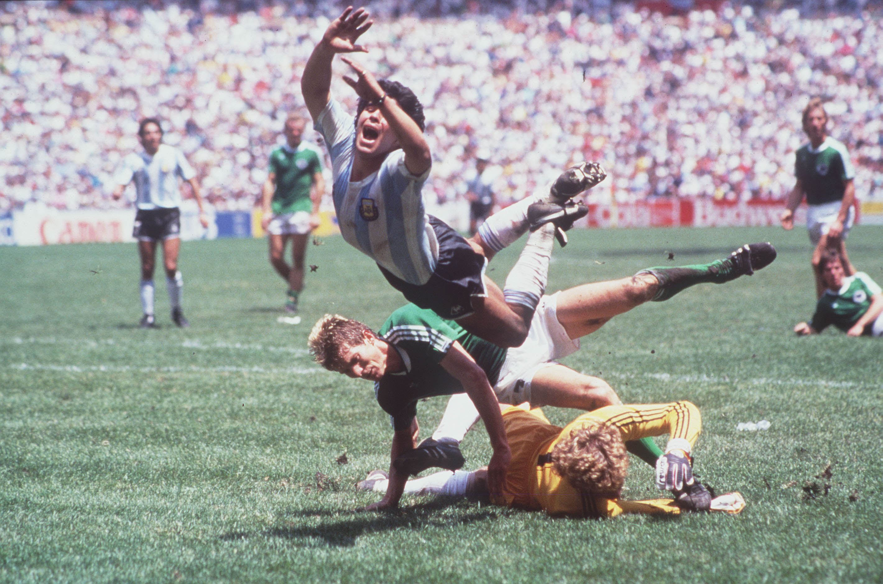 1986 World Cup Final, Azteca Stadium, Mexico, 29th June, 1986, Argentina 3 v West Germany 2, Argentina's Diego Maradona goes flying over the challenges of West German goalkeeper Harald Schumacher and defender Karl Heinz Foerster