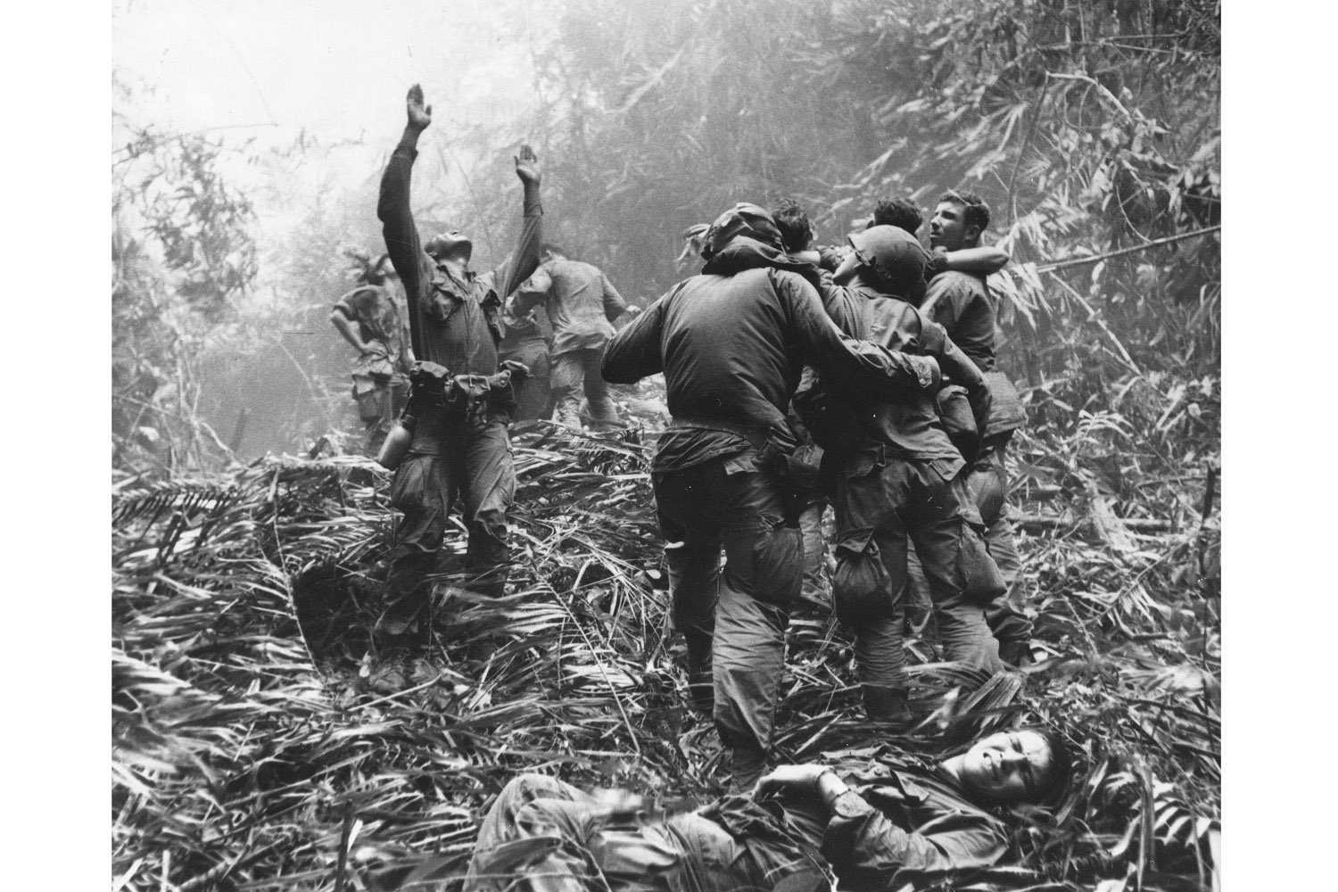As fellow troopers aid wounded buddies, a paratrooper of A Company, 101st Airborne, guides a medical evacuation helicopter through the jungle foliage to pick up casualties during a five-day patrol of an area southwest of Hue, South Vietnam, April 1968. <br><br><i>This photograph is featured on the cover of the Associated Press' new book 'Vietnam: The Real War' (Abrams, Oct. 2013).</i>