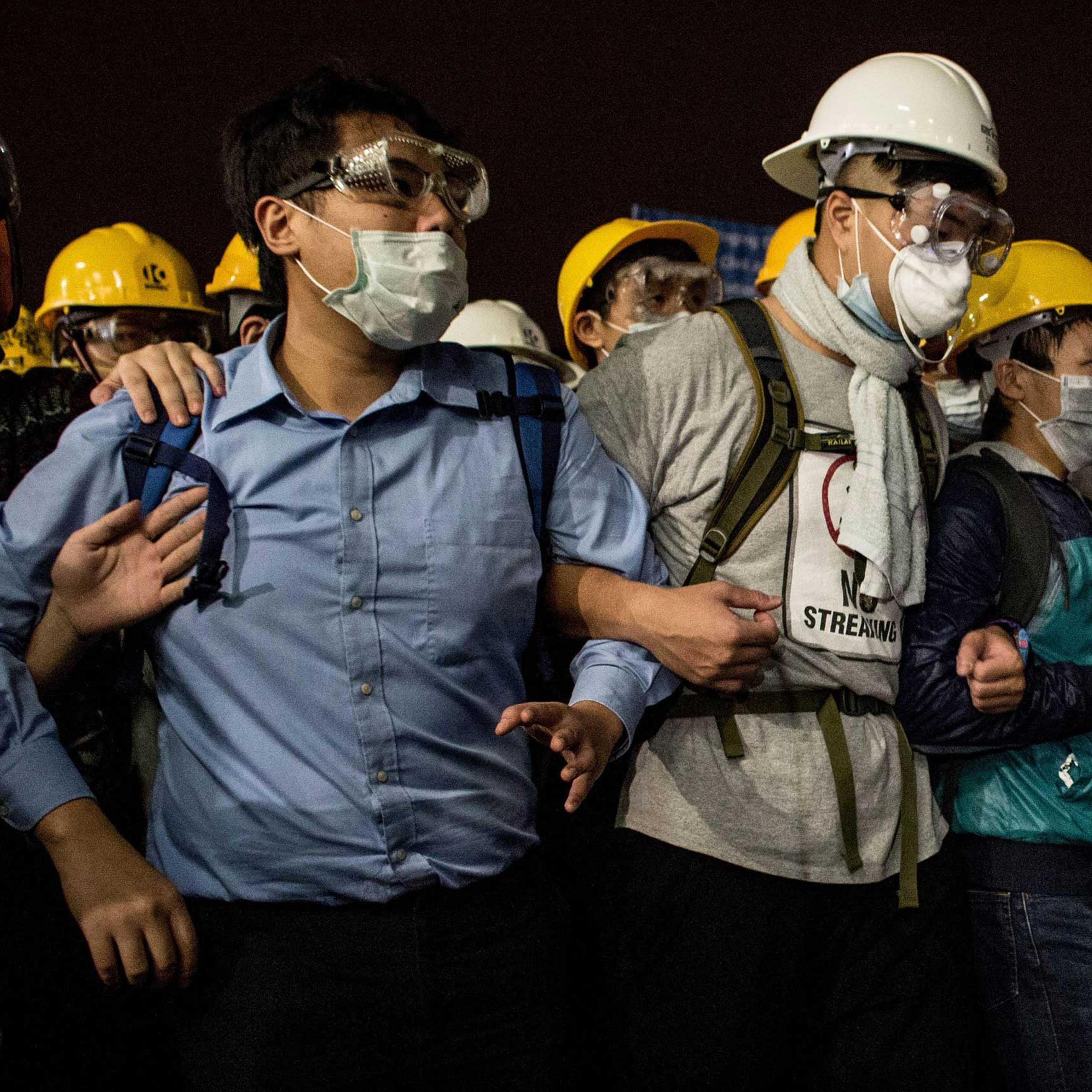 Pro-democracy activists join arms as they face off with police outside the Legislative Council building on Nov. 19, 2014 in Hong Kong.