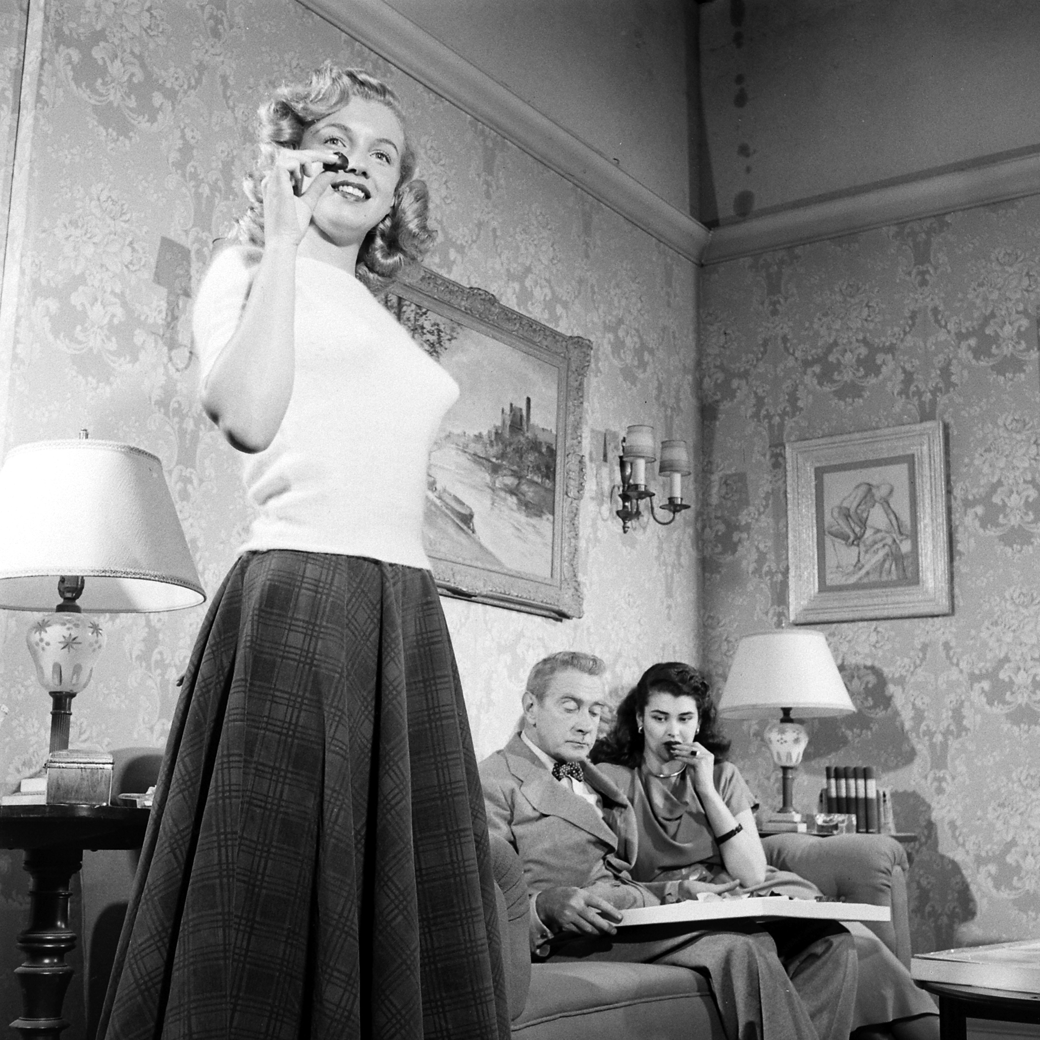 Then-unknown actress Marilyn Monroe with Clifton Webb and Laurette Luez on the set of a 1948 comedy, "Sitting Pretty."