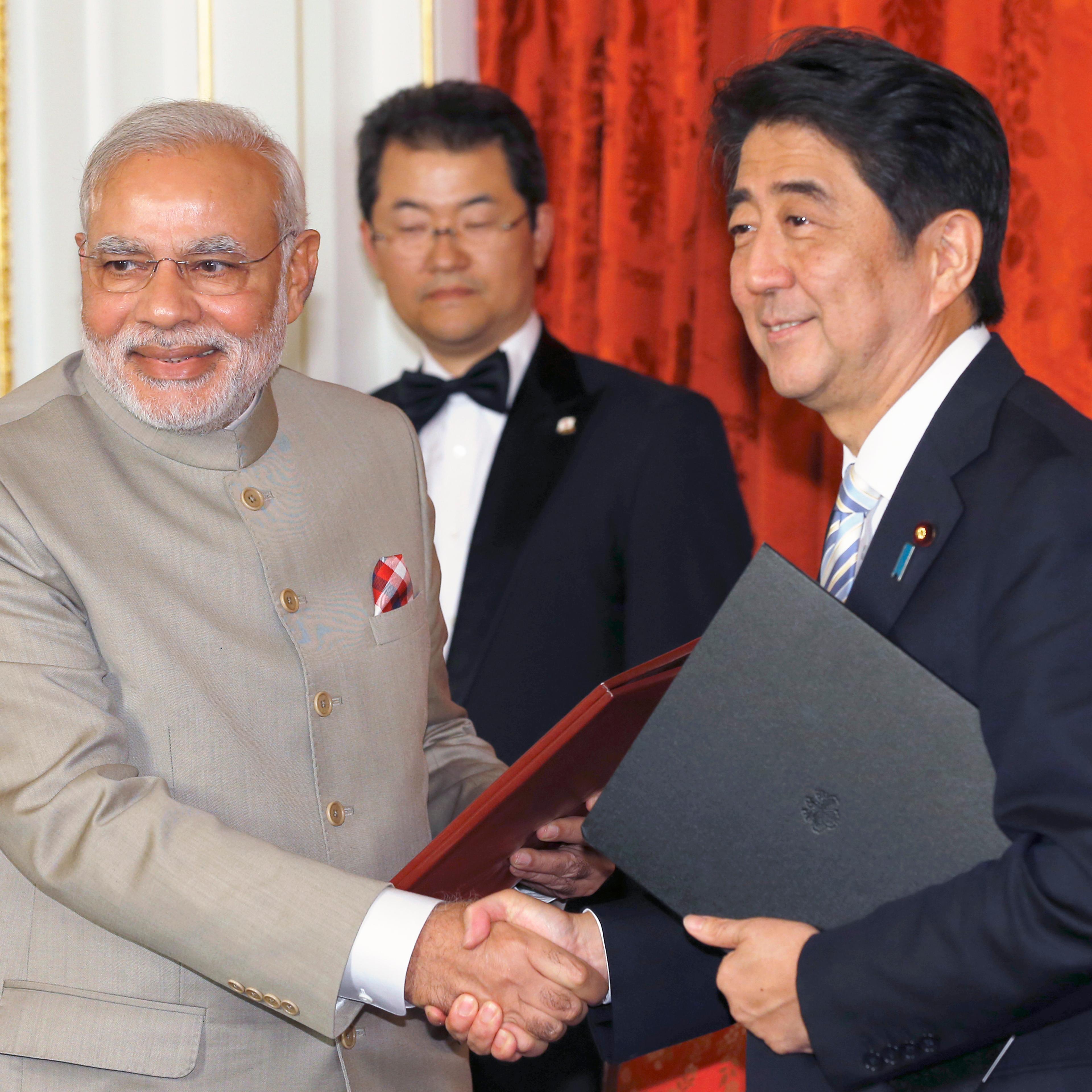 India's PM Modi shakes hands with Japan's PM Abe during a signing ceremony at the state guest house in Tokyo