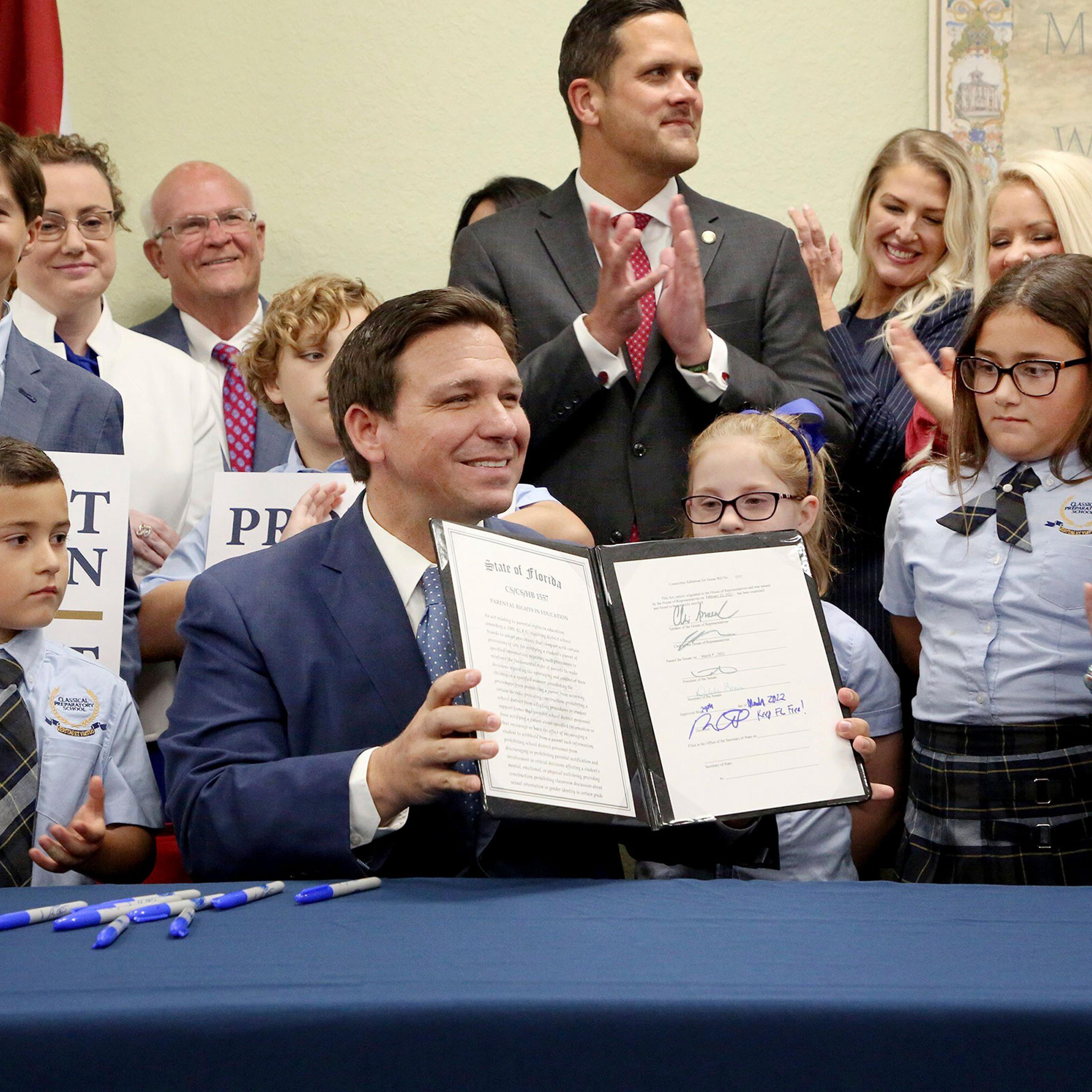 Florida Gov. Ron DeSantis displays the signed Parental Rights in Education, aka the Don't Say Gay bill, flanked by elementary school students during a news conference at Classical Preparatory school in Shady Hills, Fla. on March 28, 2022.