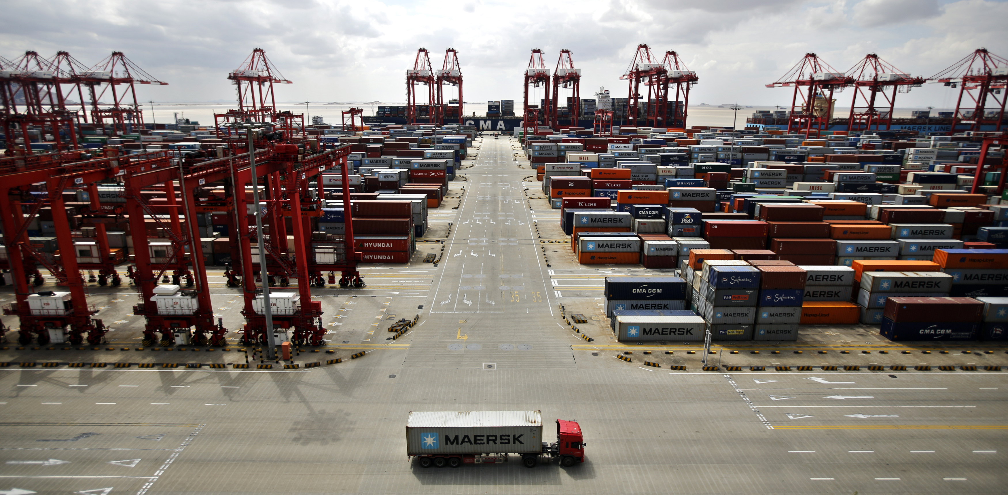 A container truck drives past the container area at the Yangshan Deep Water Port,  part of the newly announced Shanghai Free Trade Zone, south of Shanghai