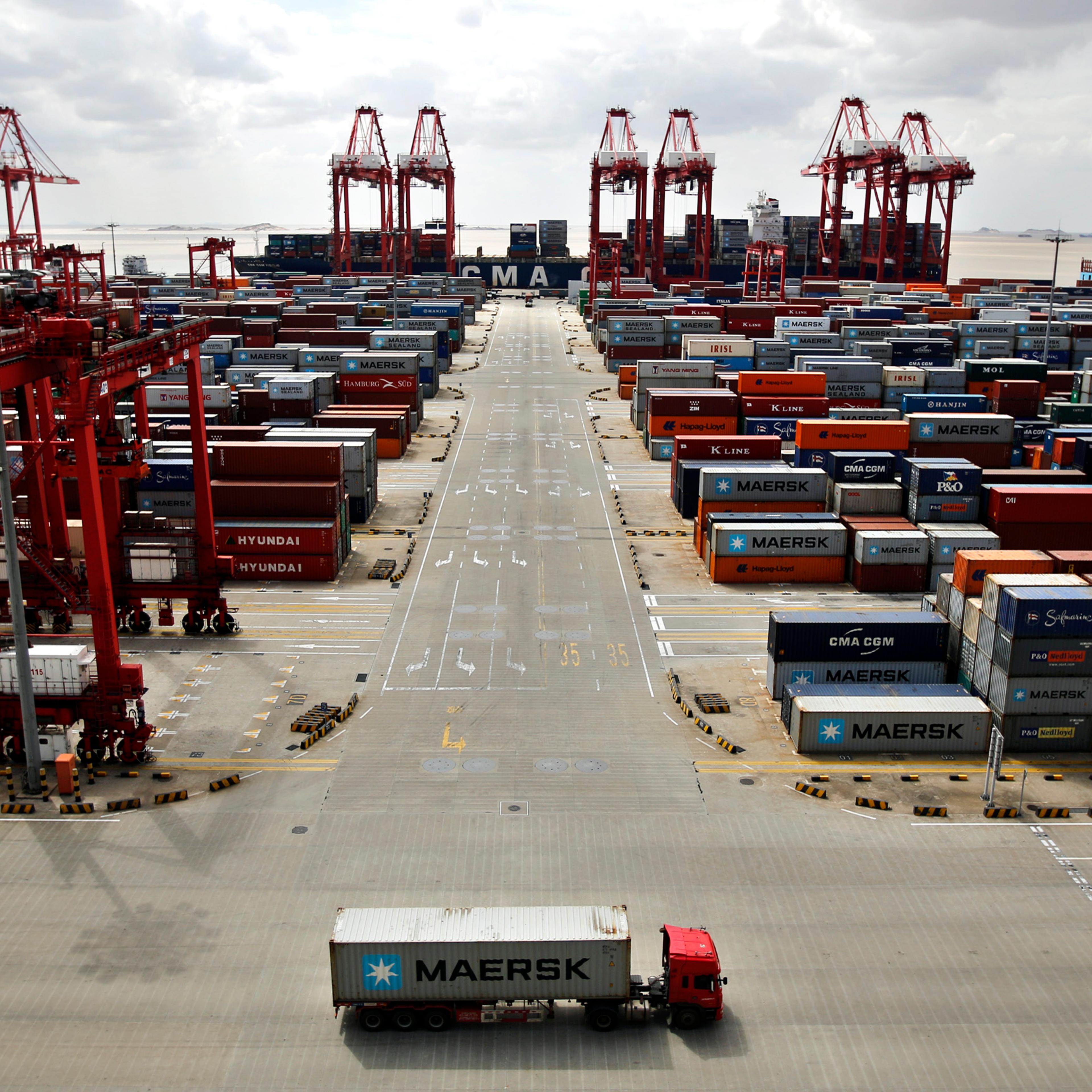 A container truck drives past the container area at the Yangshan Deep Water Port, part of the newly announced Shanghai Free Trade Zone, south of Shanghai