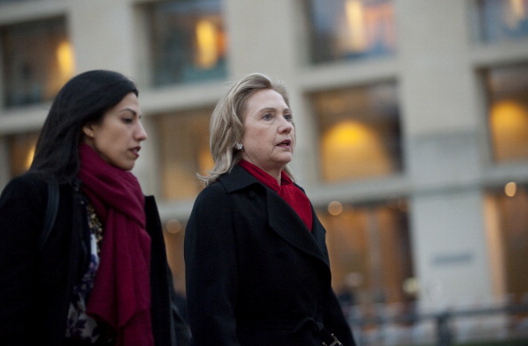US Secretary of State Hillary Clinton (R) and Deputy Chief of Staff Huma Abedin arrive for a NATO Foreign Minister family photo in front of the Brandenburg Gate in Berlin April 14, 2011.