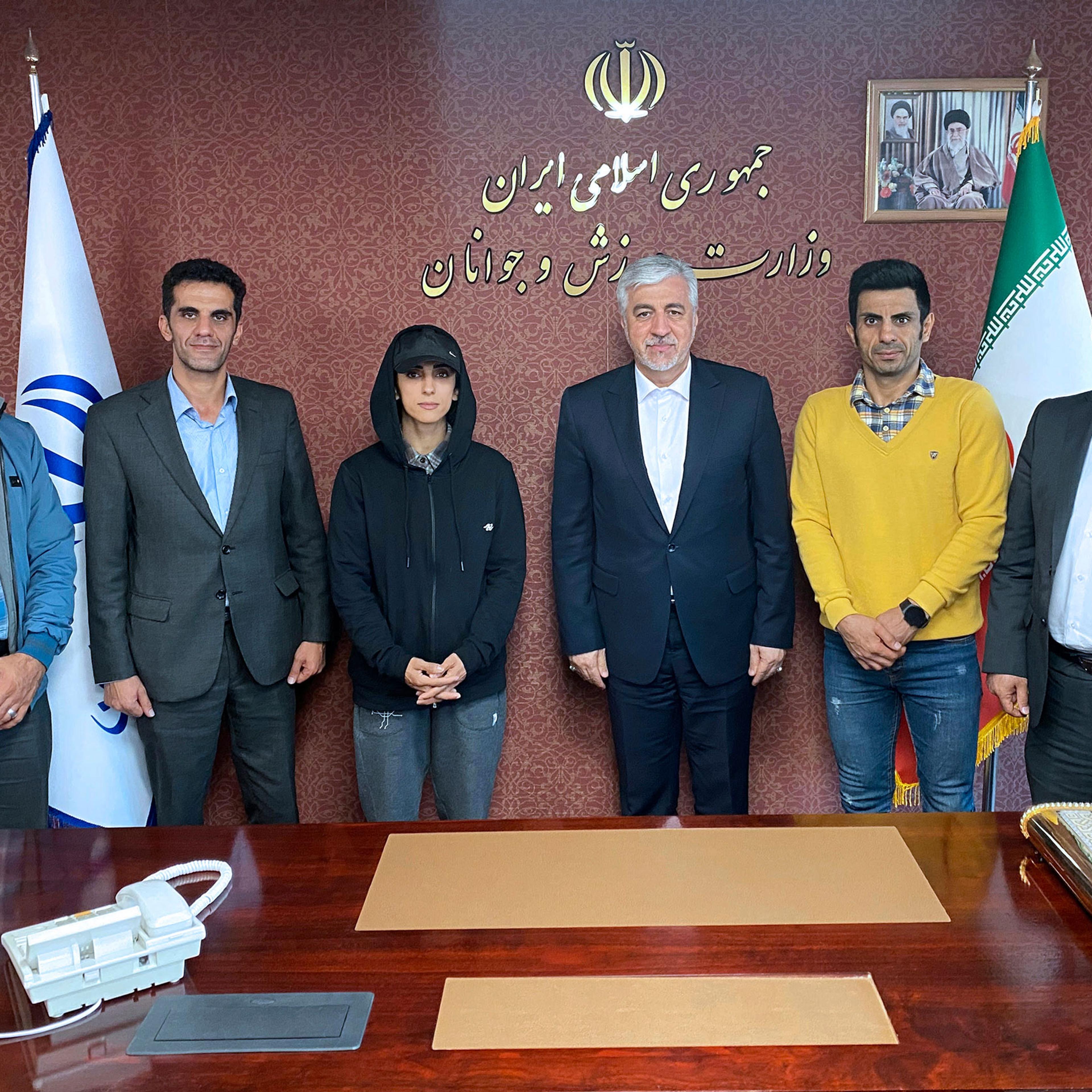 Iran’s Minister of Sport and Youth Hamid Sajjadi, center right, and climber Elnaz Rekabi, center left, pose for a photo, in Tehran, Iran, on Wednesday, Oct. 19, 2022.