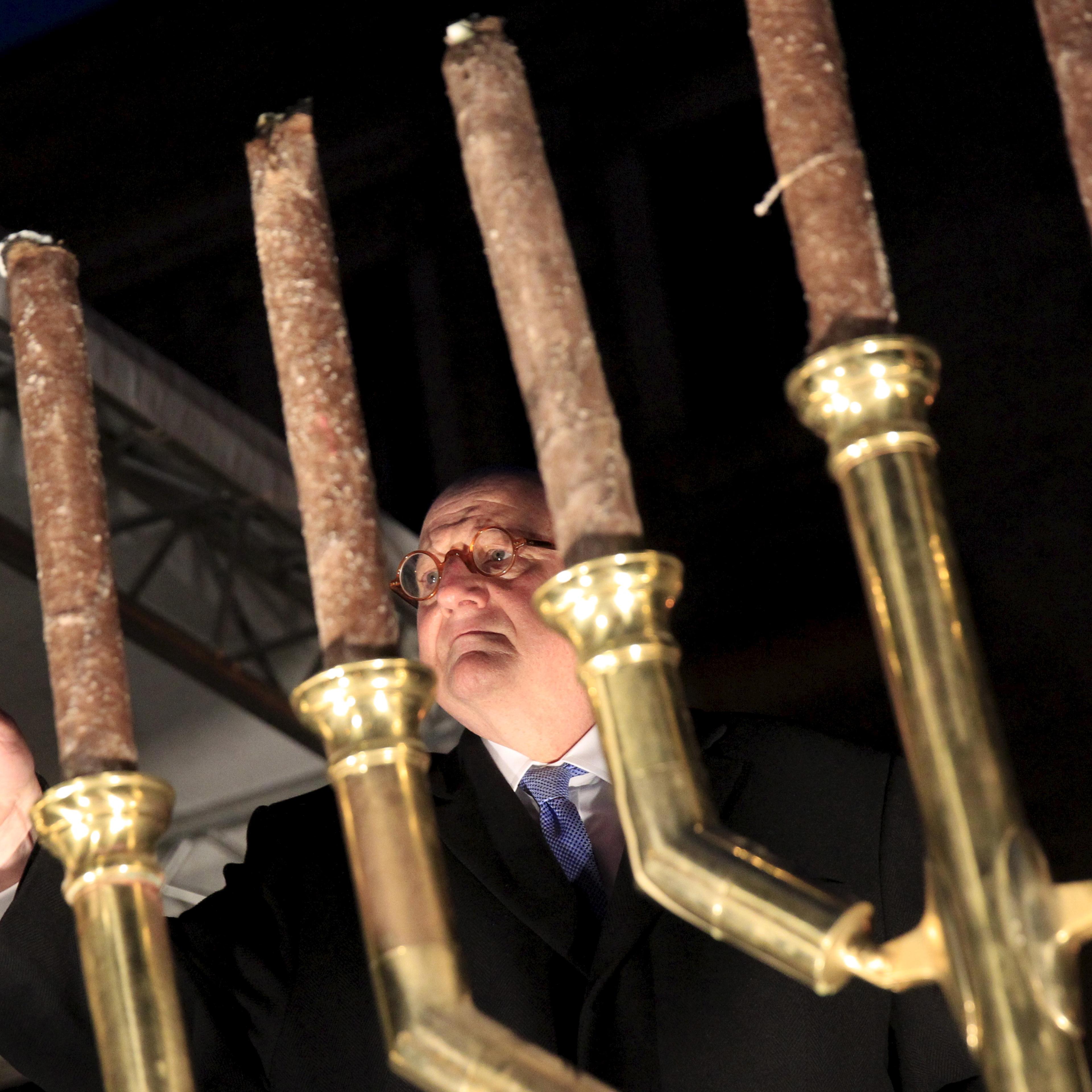 Forman, U.S. Special Envoy of the Office to Monitor and Combat Anti-Semitism, lights a menorah during a protest organised by a Jewish group against a planned statue of Balint Homan in Szekesfehervar