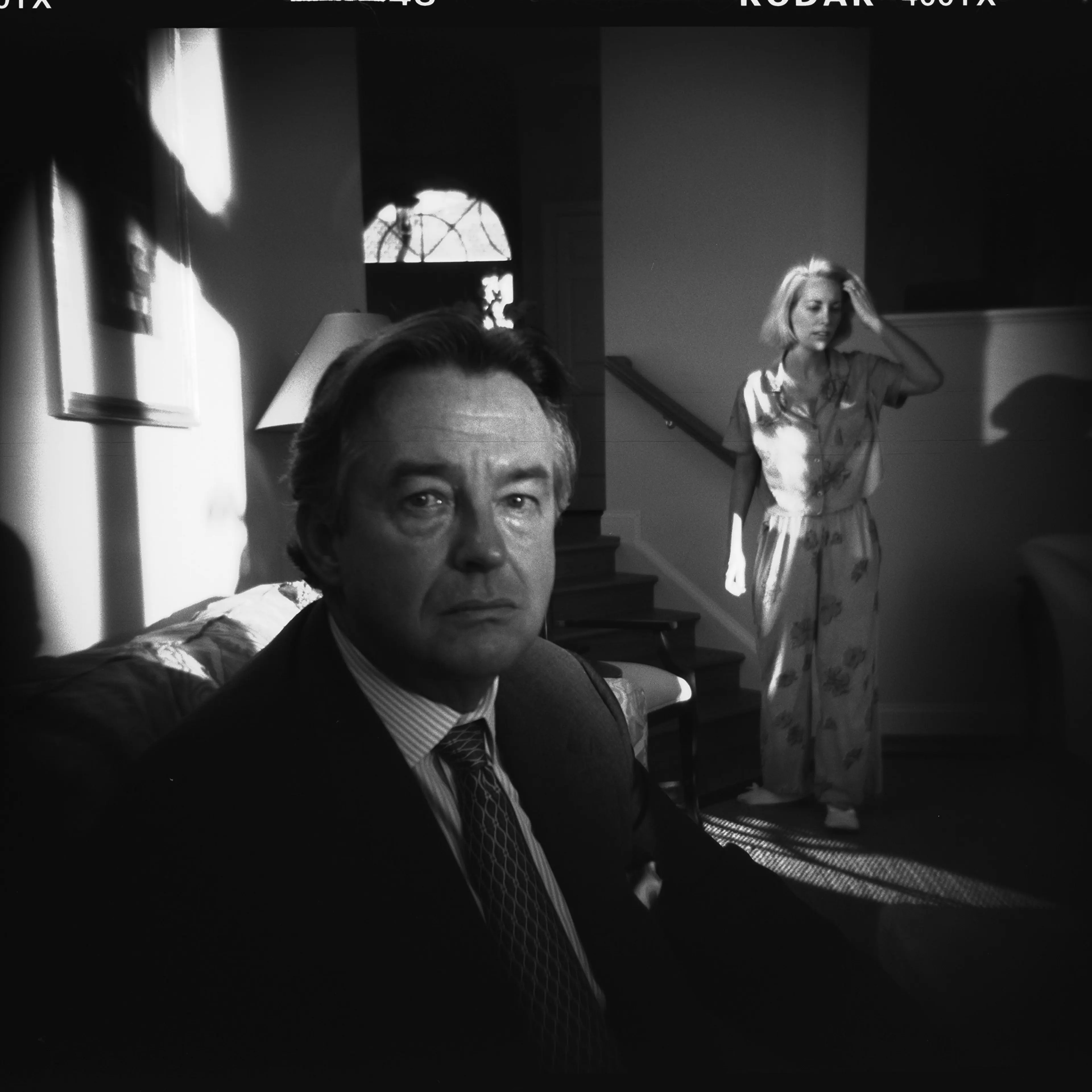 Ambassador Joseph Wilson, with his wife Valerie Plame in the background, at home in Washington, D.C., in October 2003.