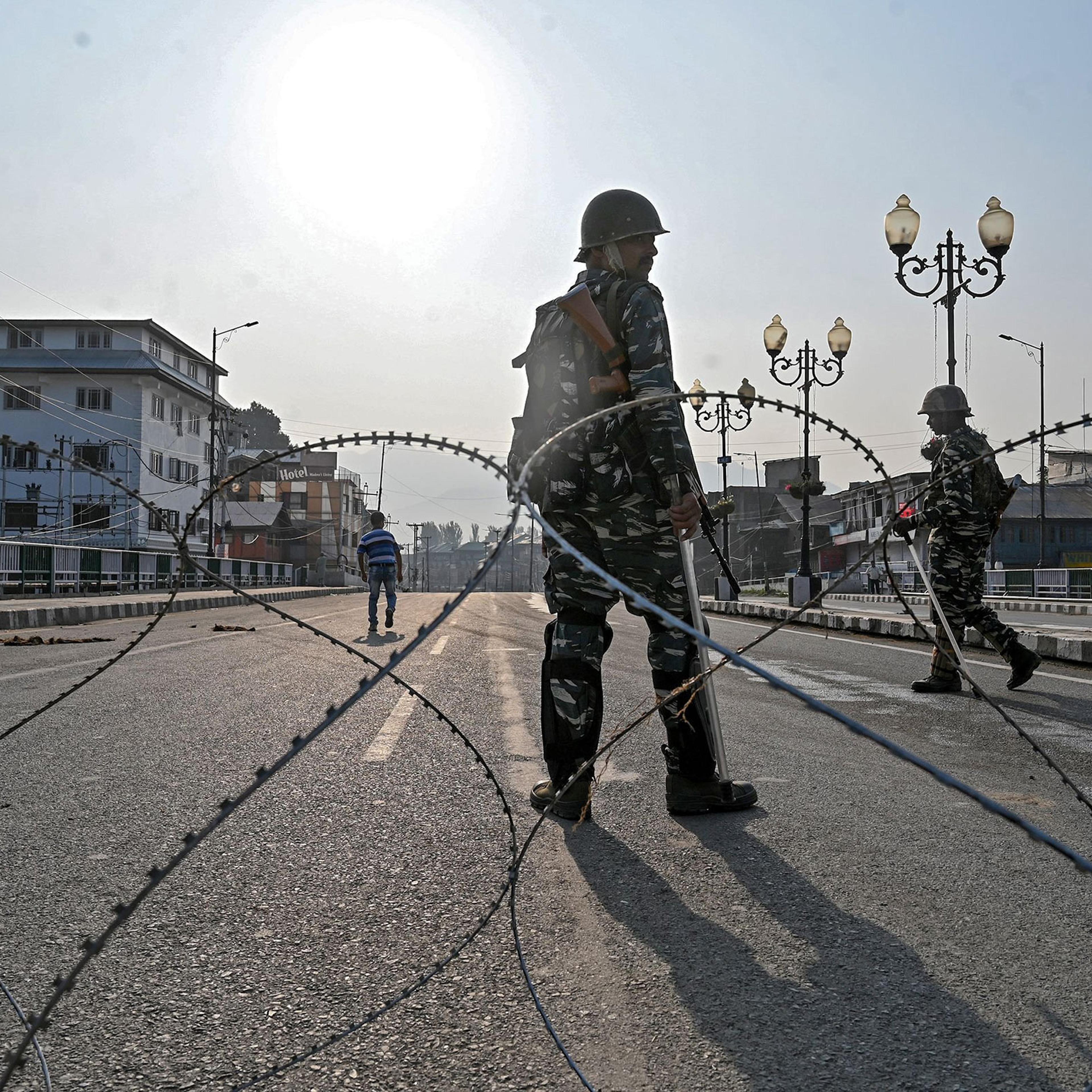 Indian troops stand guard on Aug. 5 during a curfew in the Kashmir Valley city of Srinagar.