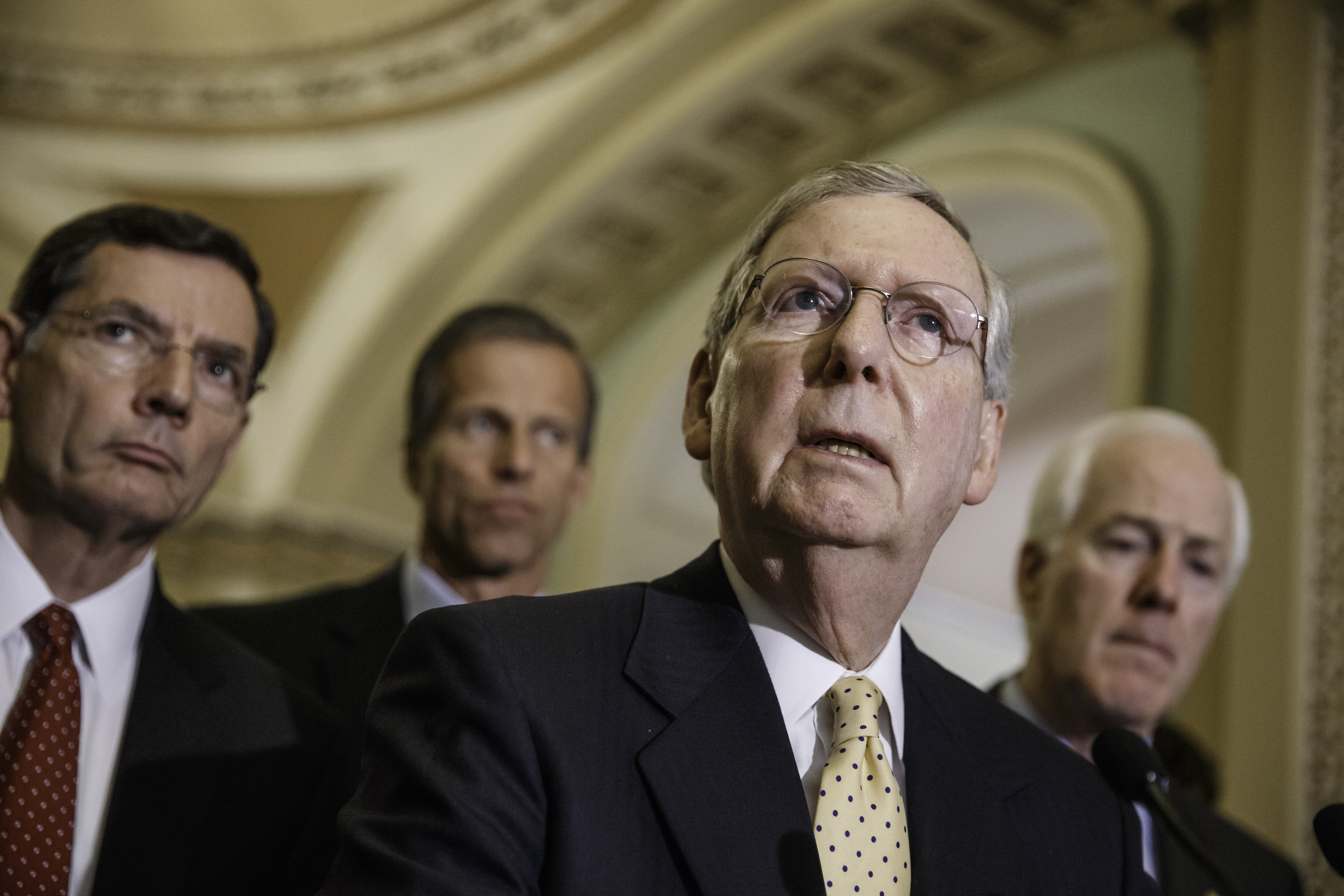 Senate Minority Leader Mitch McConnell, R-Ky., and GOP lawmakers, from left, Sen. John Barrasso, R-Wyo., Sen. John Thune, R-S.D., and Senate Minority Whip John Cornyn, R-Texas, face reporters after a Republican caucus meeting, at the Capitol in Washingto