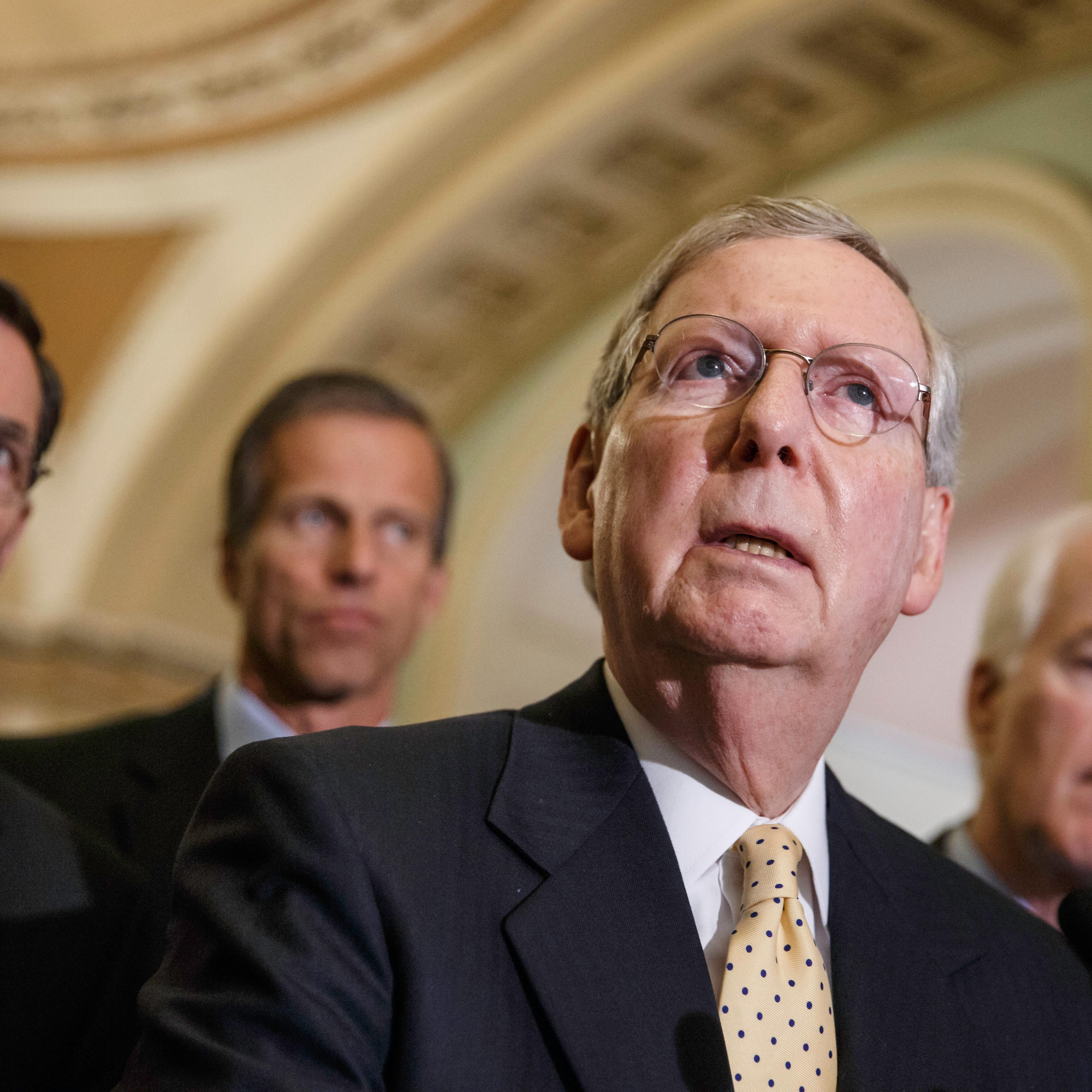 Senate Minority Leader Mitch McConnell, R-Ky., and GOP lawmakers, from left, Sen. John Barrasso, R-Wyo., Sen. John Thune, R-S.D., and Senate Minority Whip John Cornyn, R-Texas, face reporters after a Republican caucus meeting, at the Capitol in Washingto