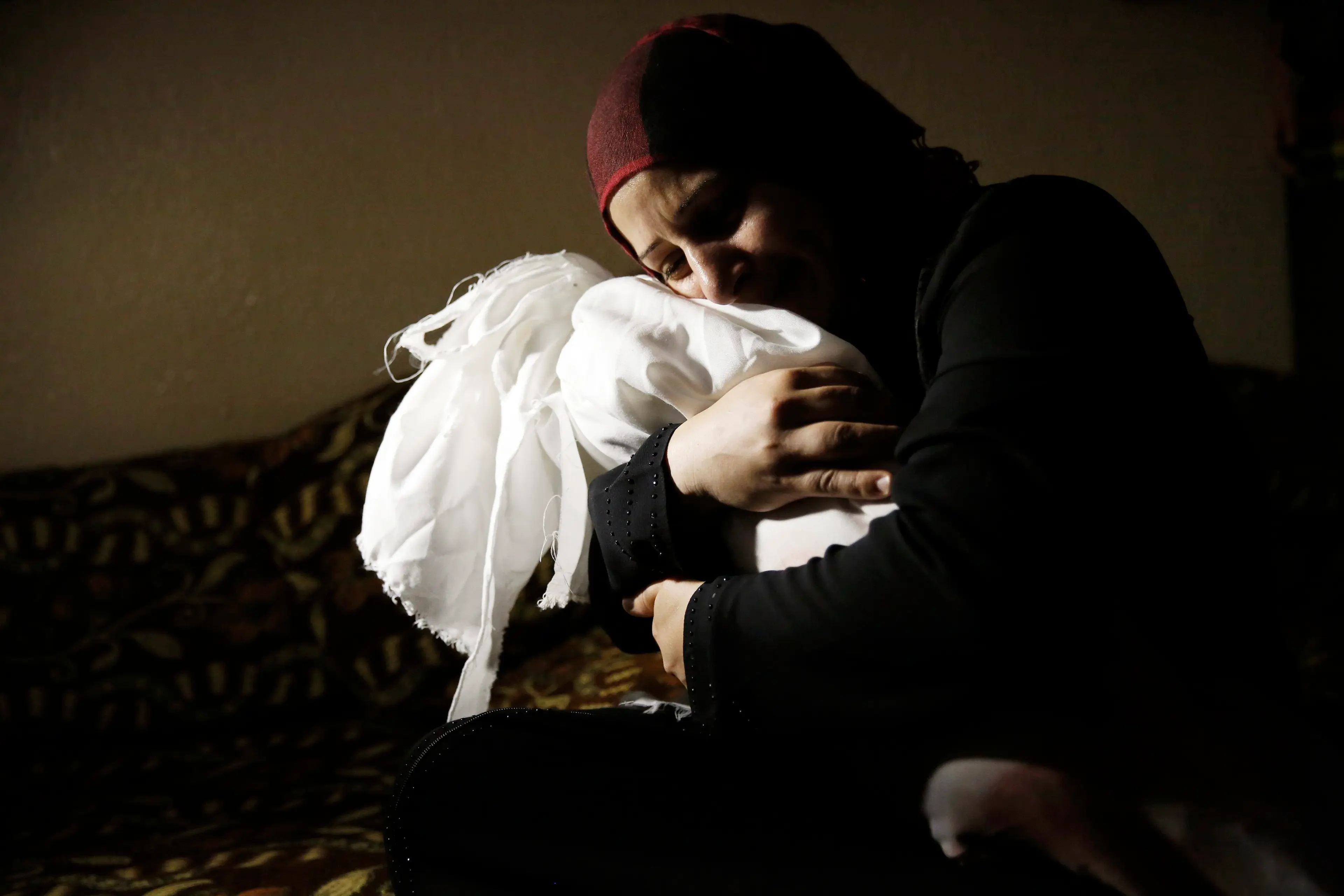 Netream Netzleam holds the body of her daughter Razel, 1, who died in an Israeli air strike on Thursday afternoon, at her funeral in Rafah in the southern Gaza Strip on July 18, 2014.