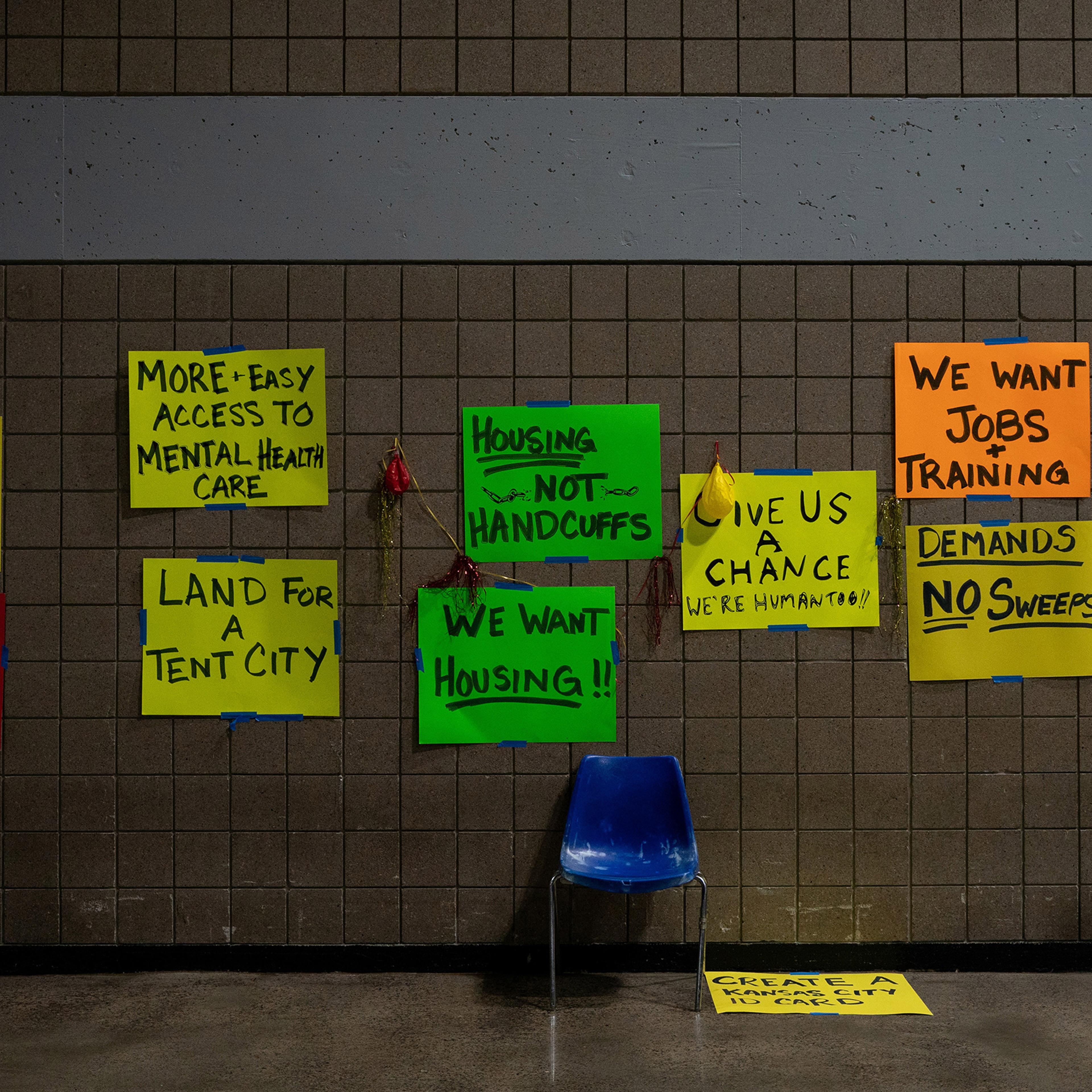 Signs at a temporary center for homeless people run by Kansas City, Mo., on Feb. 11. Cities and community groups are wrestling with how to shelter a vulnerable population without exposing it to an airborne virus that spreads most easily indoors.