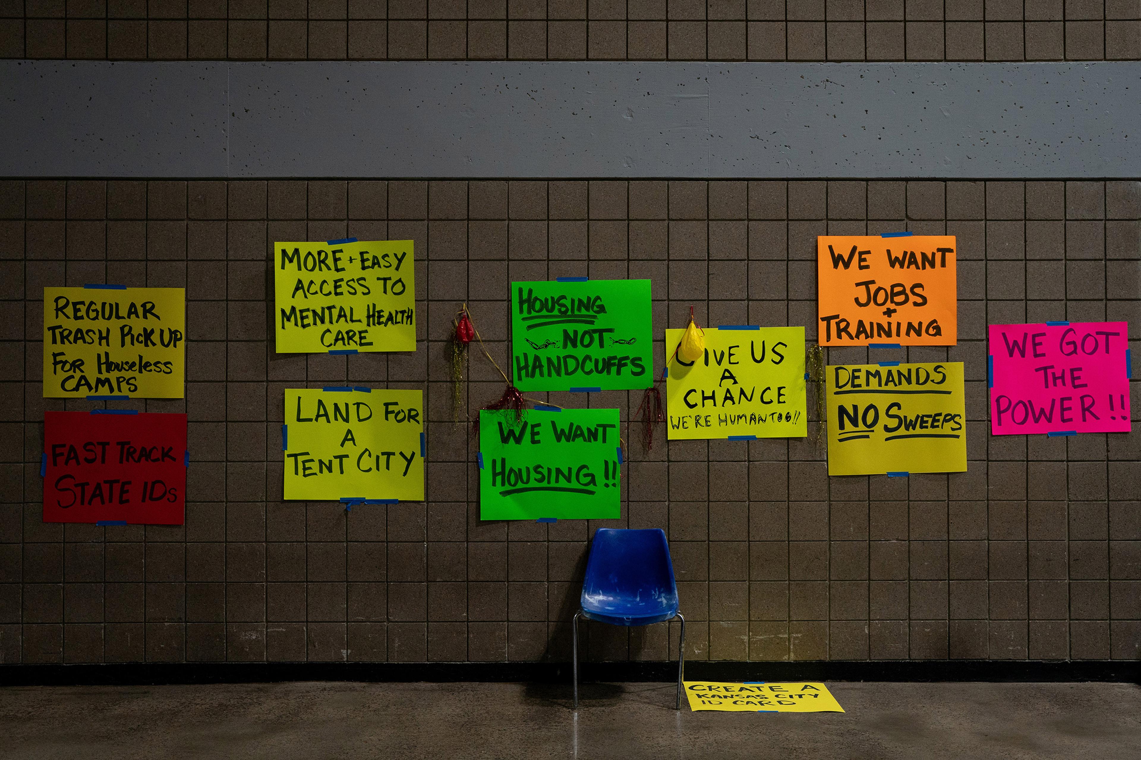 Signs at a temporary center for homeless people run by Kansas City, Mo., on Feb. 11. Cities and community groups are wrestling with how to shelter a vulnerable population without exposing it to an airborne virus that spreads most easily indoors.