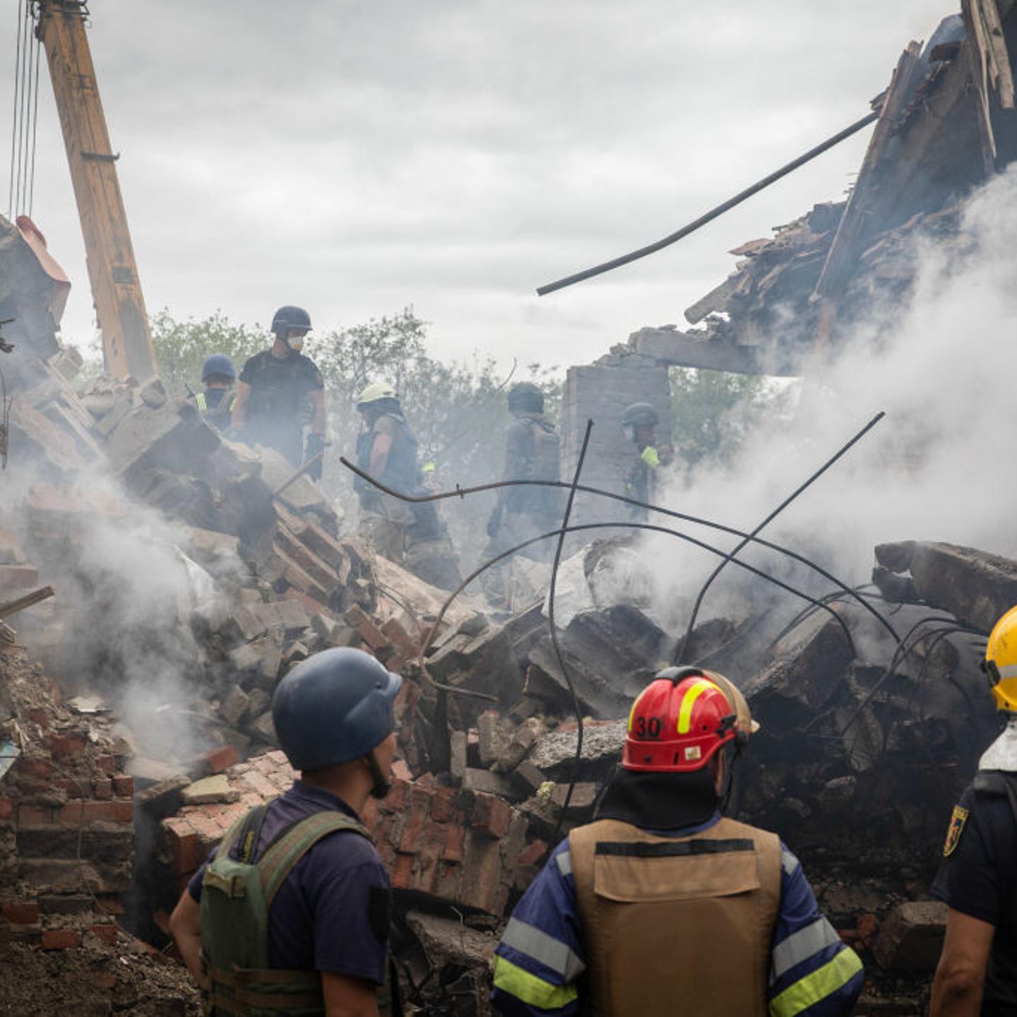 Ukrainian personnel search for survivors in the ruins of the