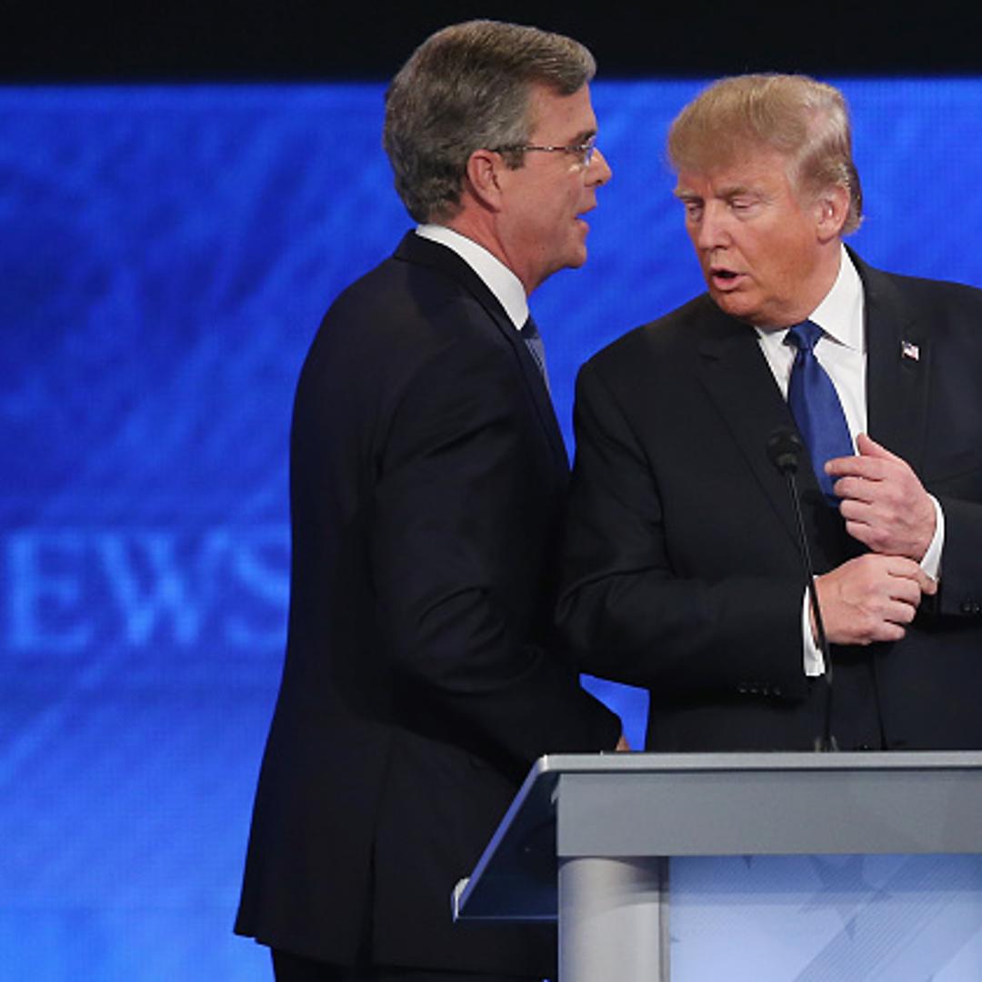 Republican presidential candidates Jeb Bush (L) and Donald Trump talk following the Republican presidential debate at St. Anselm College February 6, 2016 in Manchester, New Hampshire.