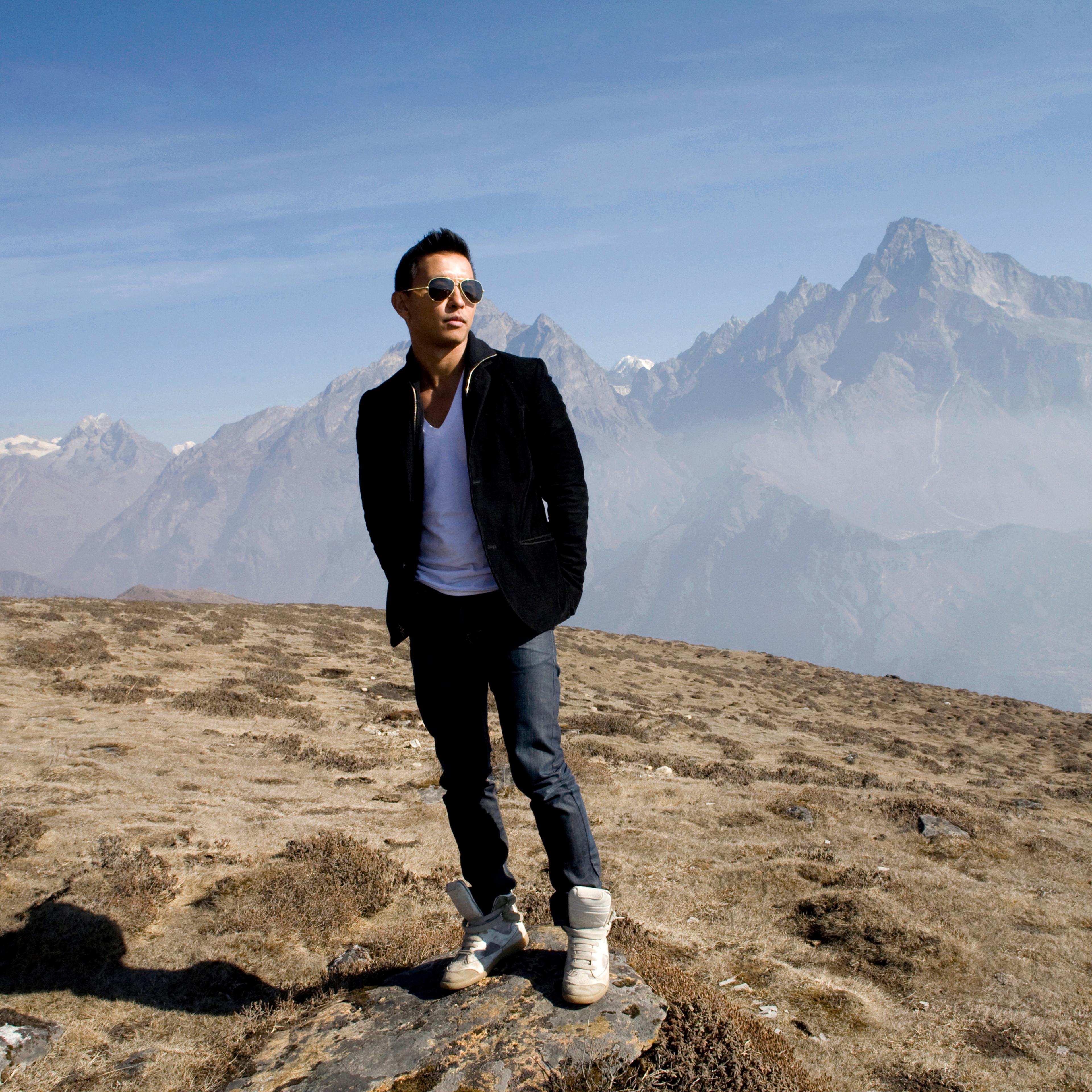 Nepali fashion designer Prabal Gurun poses at the foot of Kondge mountain at more than 13,000 feet above sea level, with the Khumbu valley behind him on April 7, 2010.