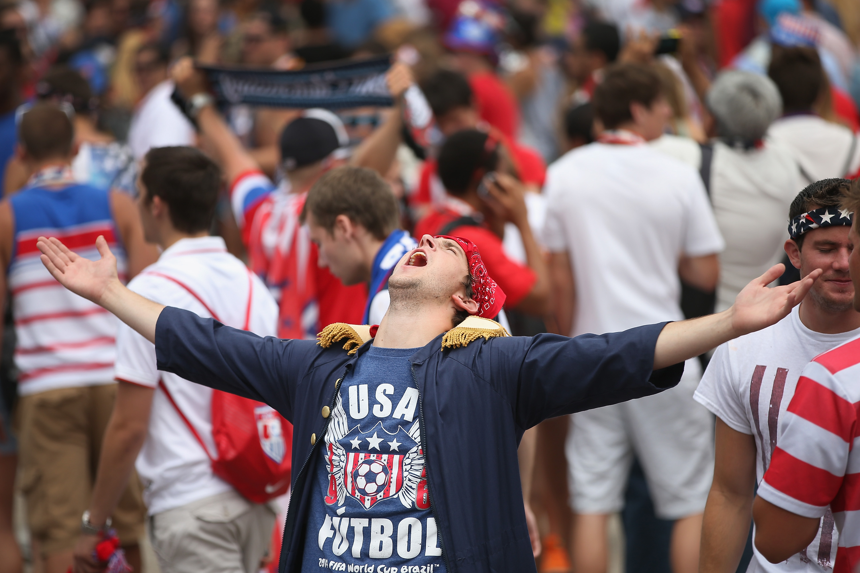 Fans celebrate after learning team USA would advance to the next round of World Cup soccer play while watching USA play Germany on one of two large screens placed in Grant Park on June 26, 2014 in Chicago.