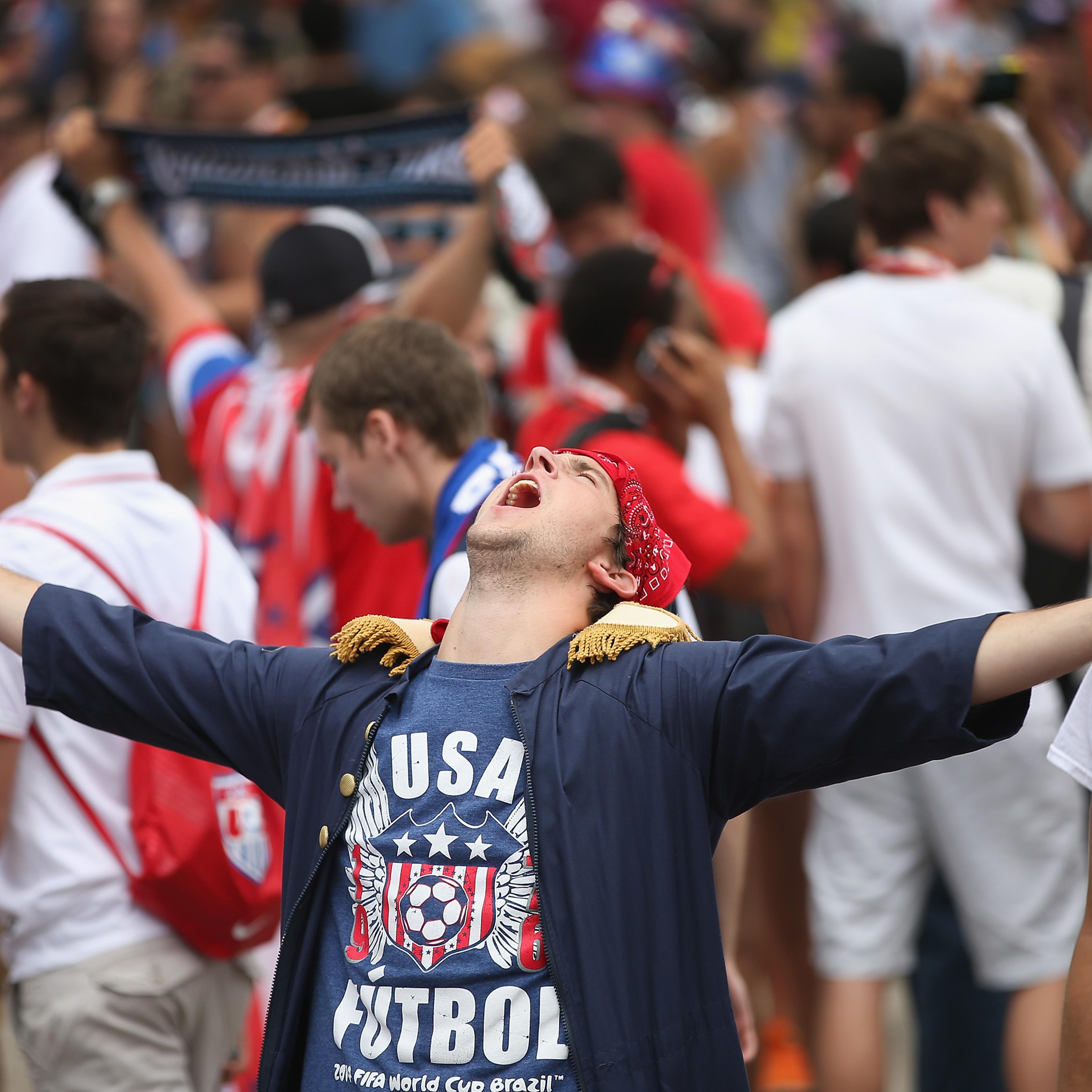 Fans celebrate after learning team USA would advance to the next round of World Cup soccer play while watching USA play Germany on one of two large screens placed in Grant Park on June 26, 2014 in Chicago.