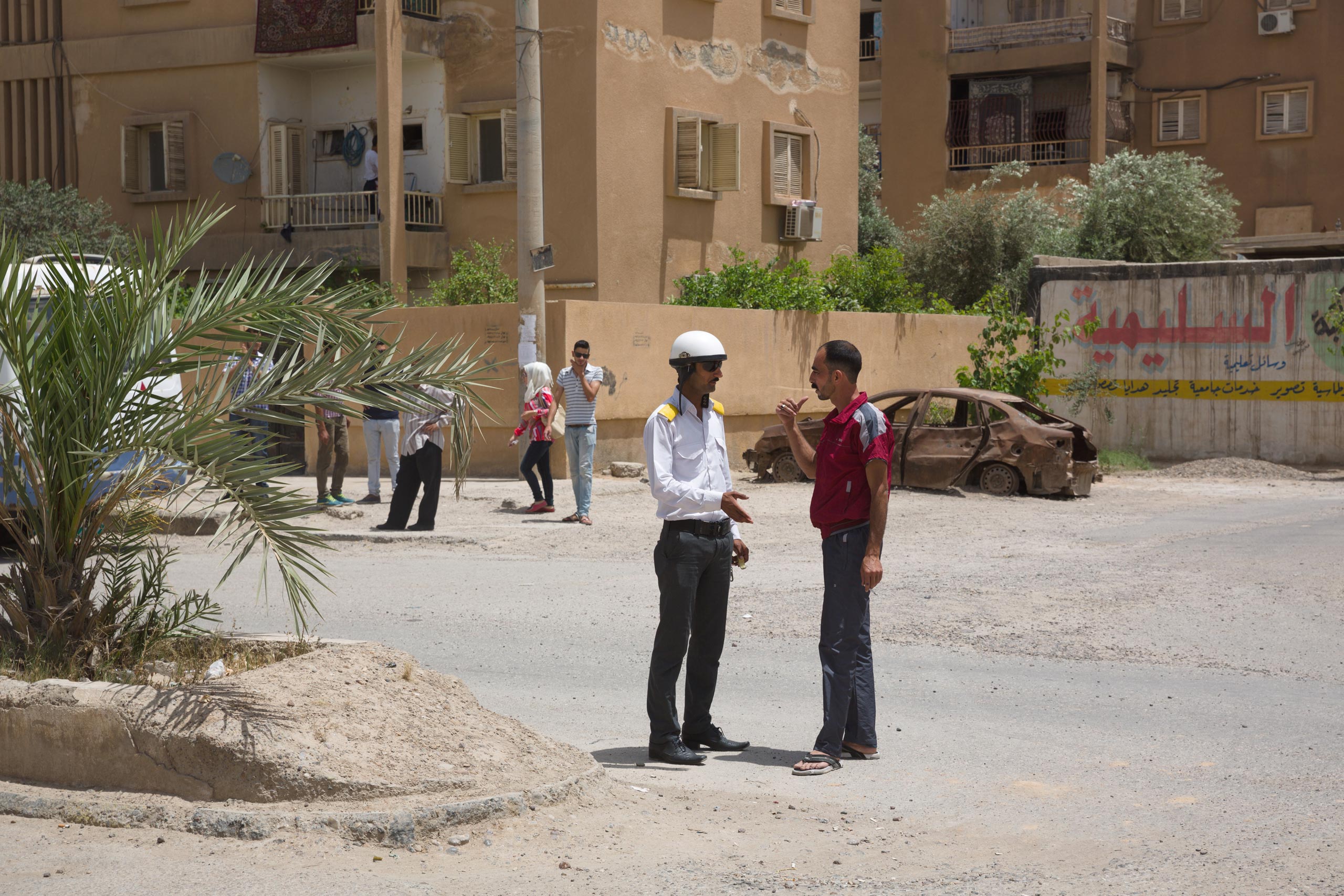 Traffic cops in black trousers, pressed white shirts and white helmets direct traffic on the mostly empty roads of Deir-ez Zor. Because of the ISIS blockade of the city, however, electricity and water have been cut off, and there is no fuel for cars, May 25, 2015.