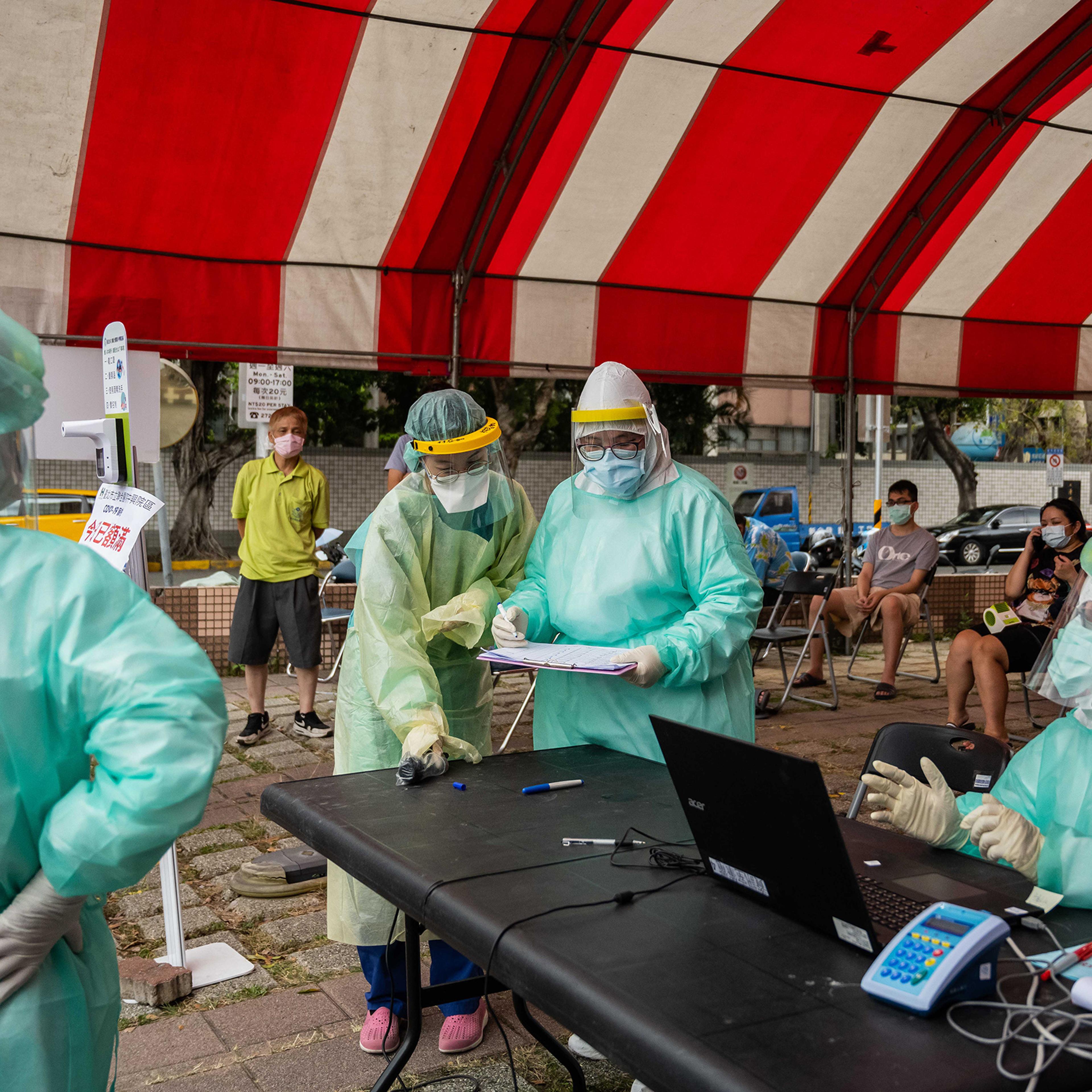 Health care workers at a temporary COVID-19 rapid testing site in Taipei on May 17, 2021.