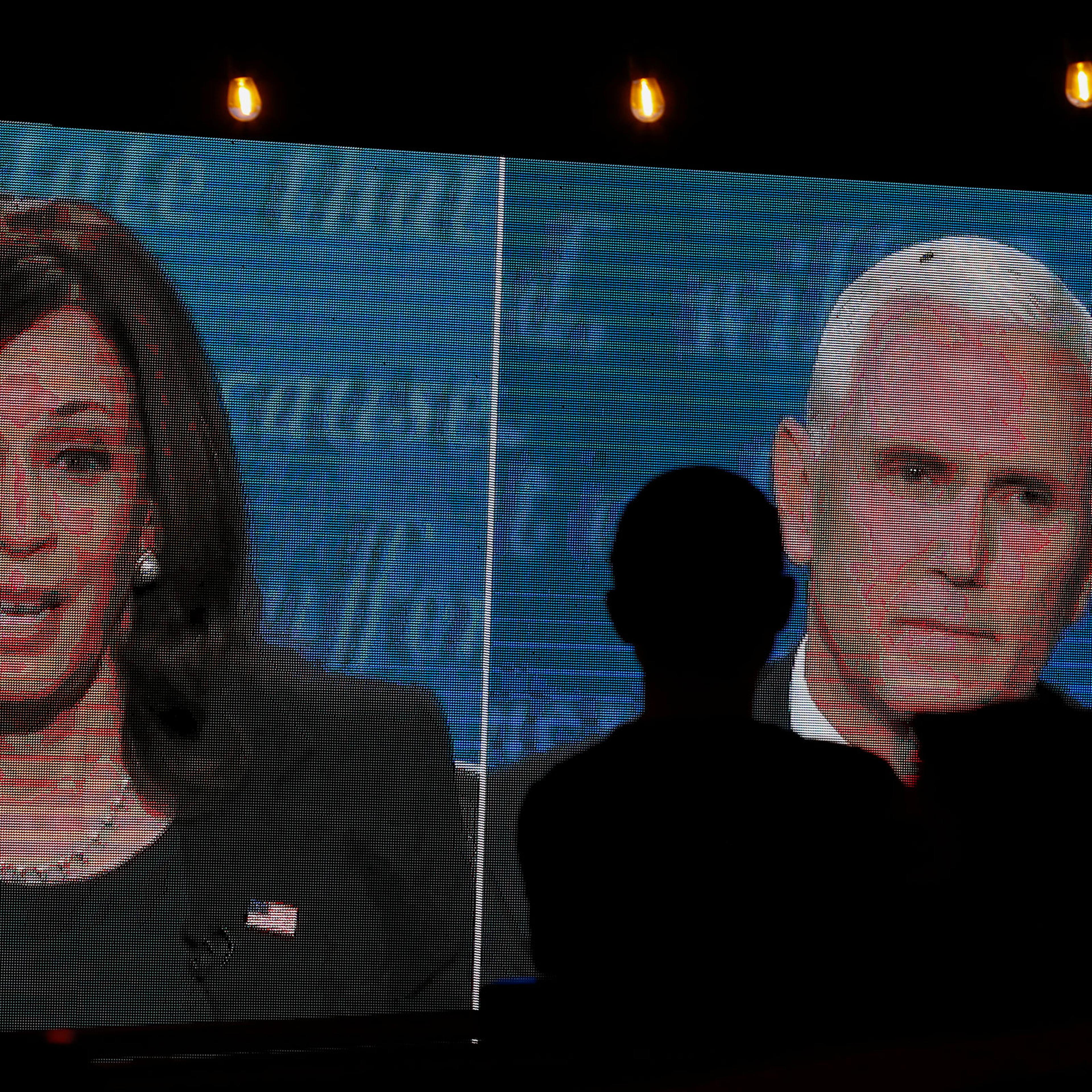 People watch the debate between Vice President Mike Pence and Democratic vice-presidential nominee Sen. Kamala Harris outside a tavern in San Diego, Calif., on Oct. 7, 2020.