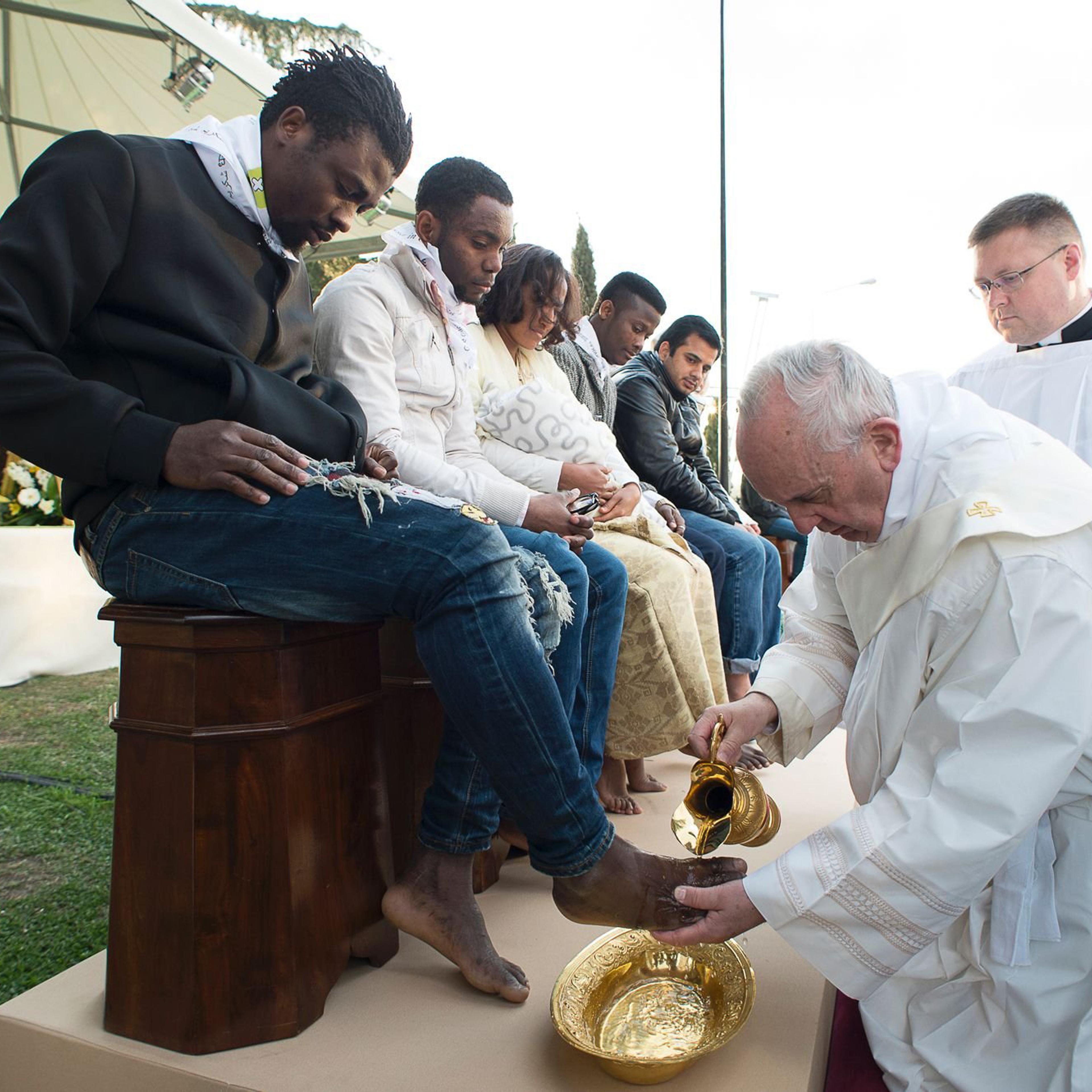 In this handout picture released by the Vatican Press Office, Pope Francis performs the foot-washing ritual at the Castelnuovo di Porto refugees center near Rome, Italy on March 24, 2016. Pope Francis washed the feet of 11 young asylum seekers and a work