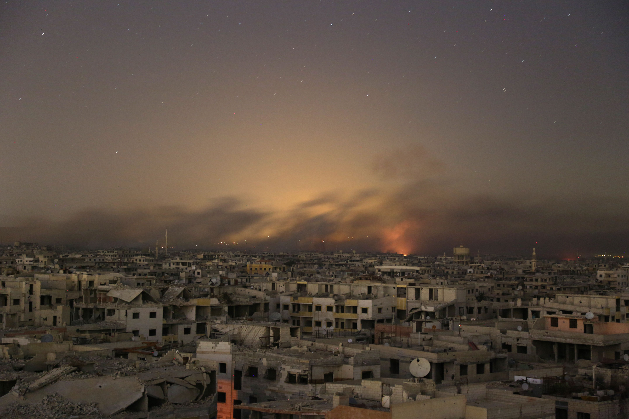 Smoke rises during Syrian government bombardment on the rebel-controlled town of Arbin, in the besieged Eastern Ghouta region on the outskirts of the capital Damascus, on late March 11, 2018.