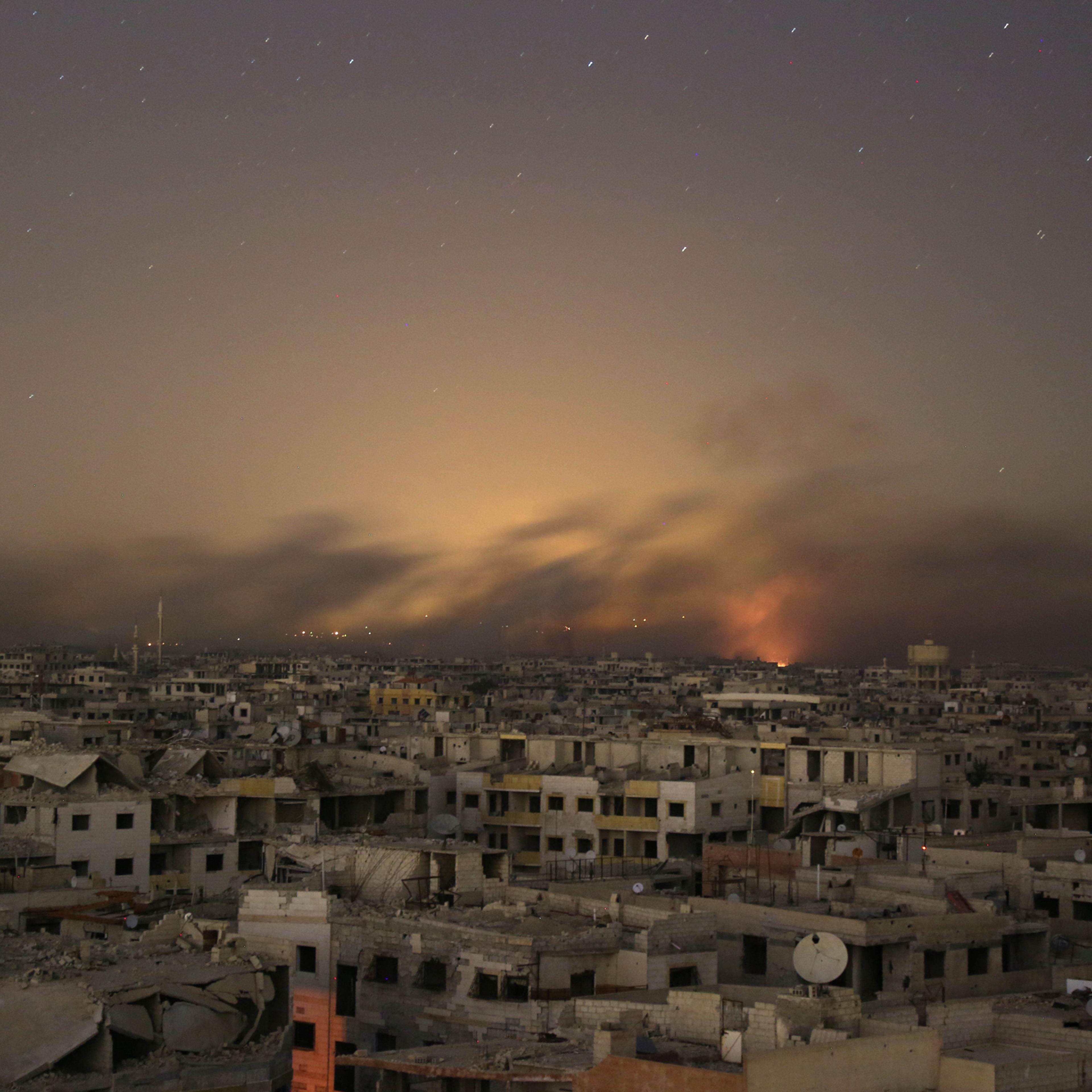 Smoke rises during Syrian government bombardment on the rebel-controlled town of Arbin, in the besieged Eastern Ghouta region on the outskirts of the capital Damascus, on late March 11, 2018.