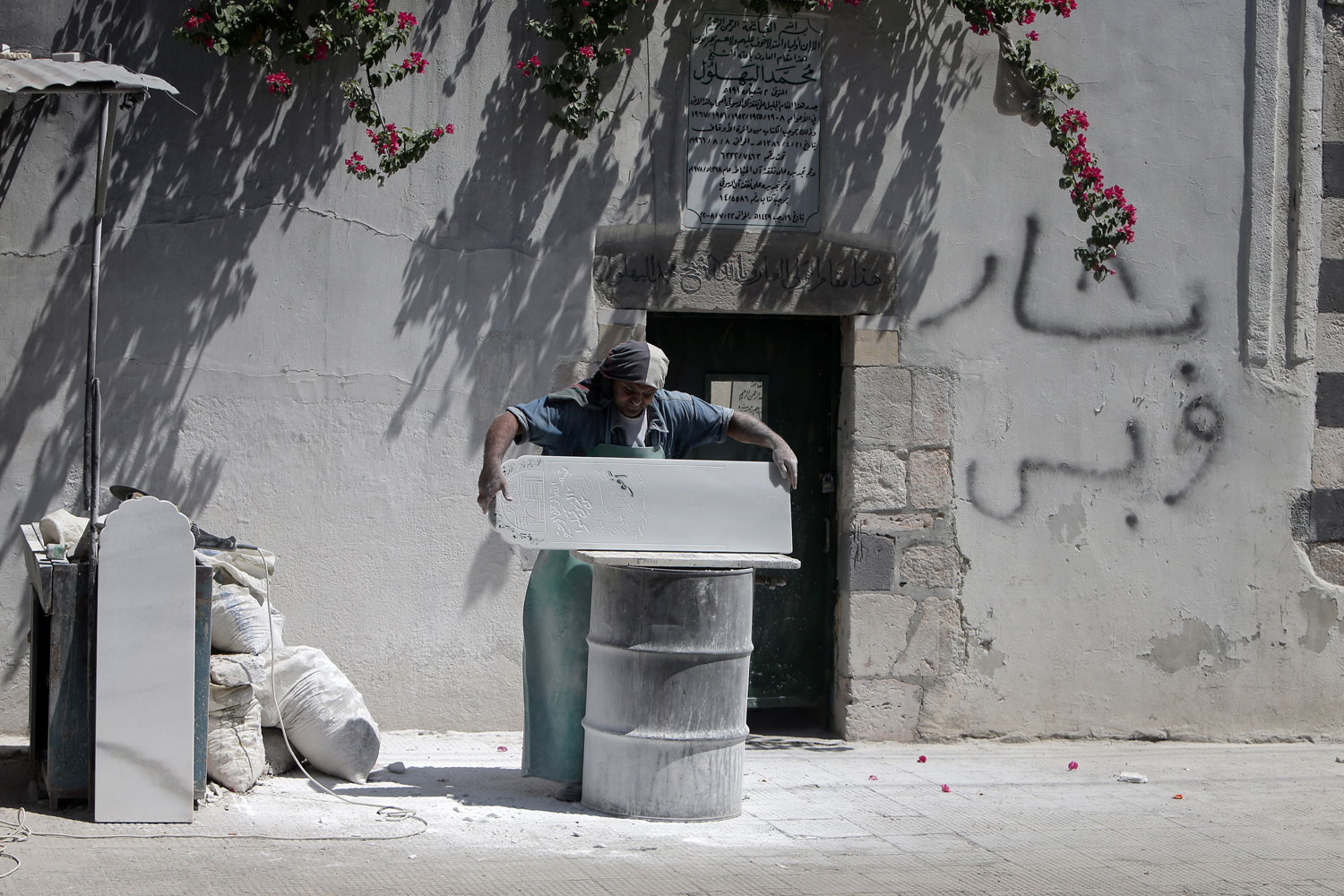 Aug. 28, 2012. A Syrian tombstone sculptor works at his workshop in Damascus.  
