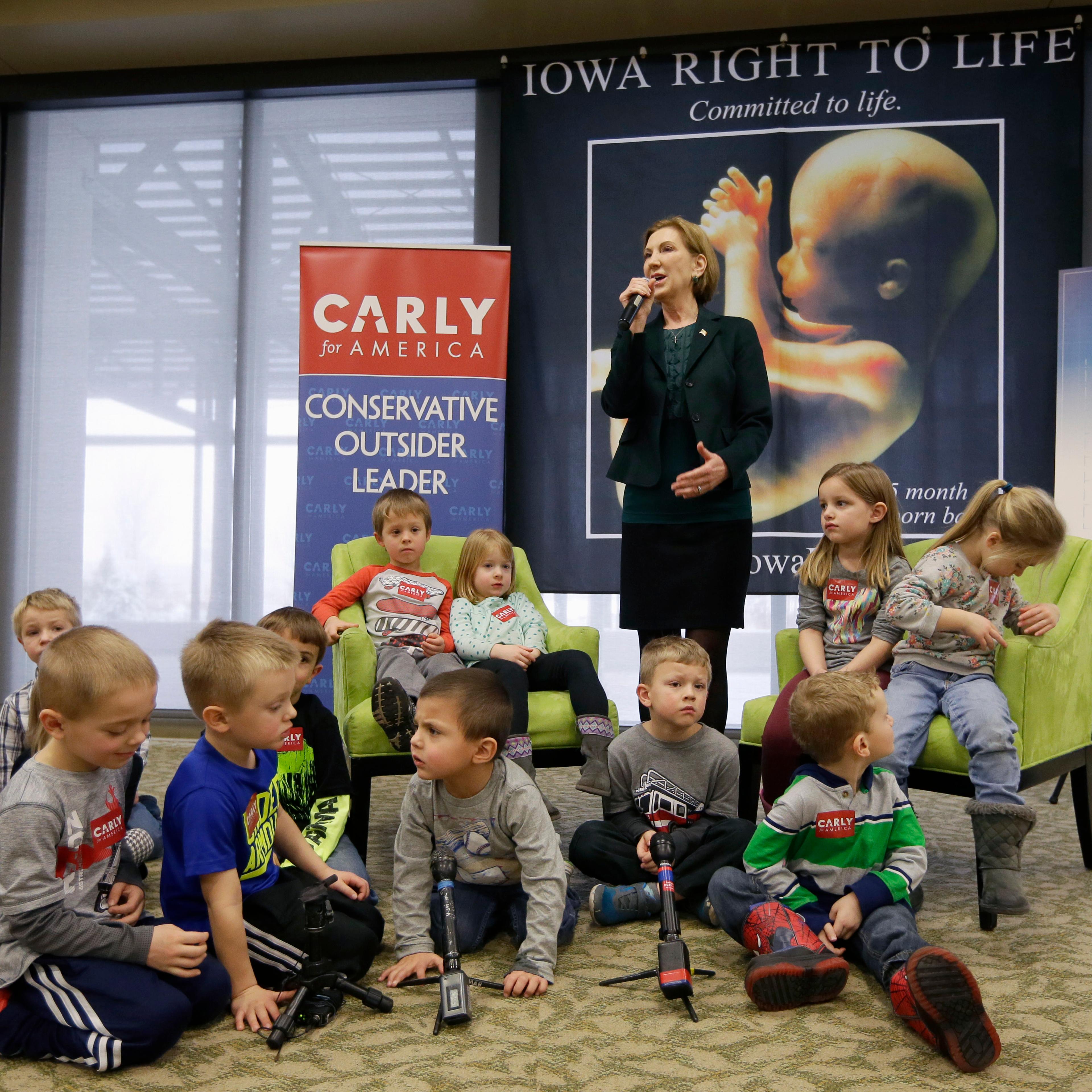 Republican presidential candidate Carly Fiorina is surrounded by preschool students as she speaks during the Iowa Right to Life Presidential Forum in Des Moines, Iowa on Jan. 20, 2016.