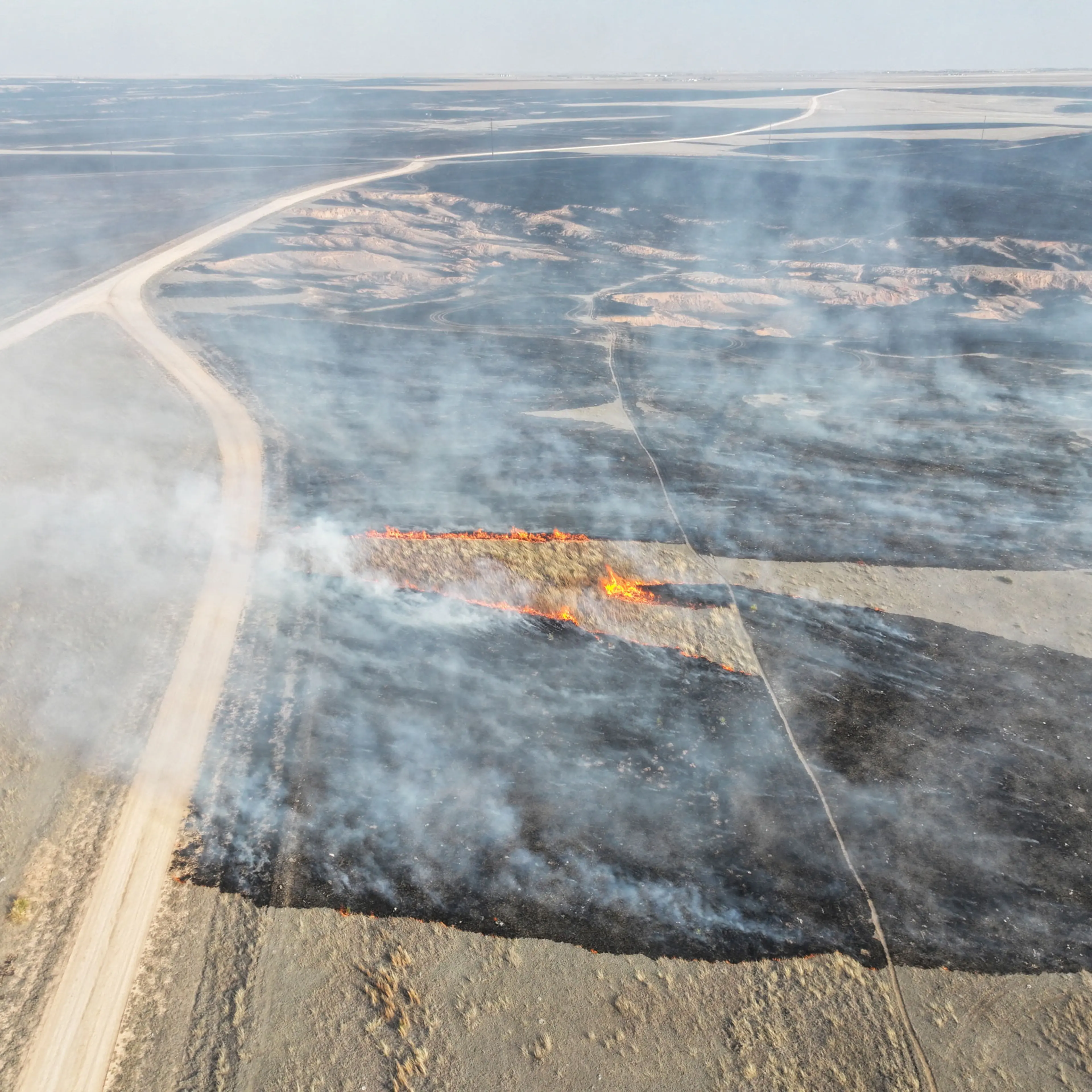 A drone view of the grasslands burning from the Smokehouse Creek Fire in Roberts County