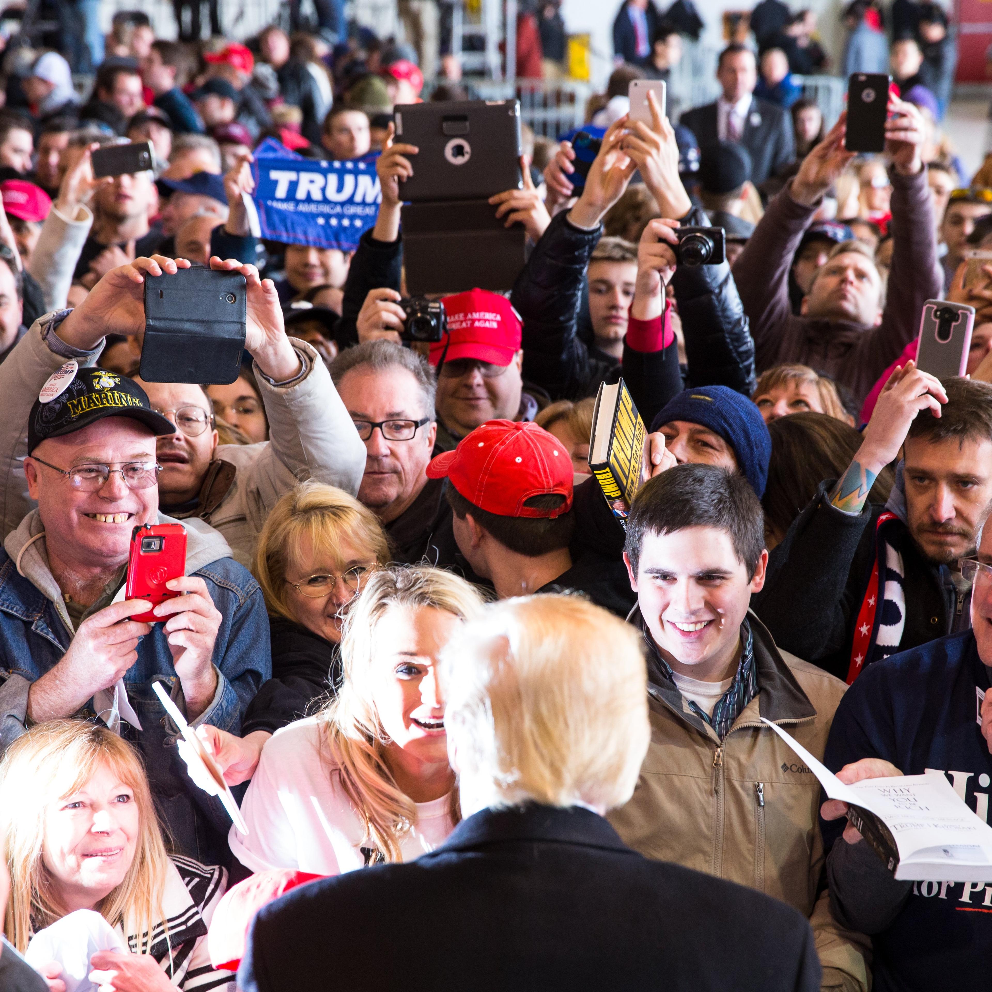 Republican presidential candidate Donald Trump greets the crowd at a rally for his campaign in Rochester, New York on April 10, 2016.