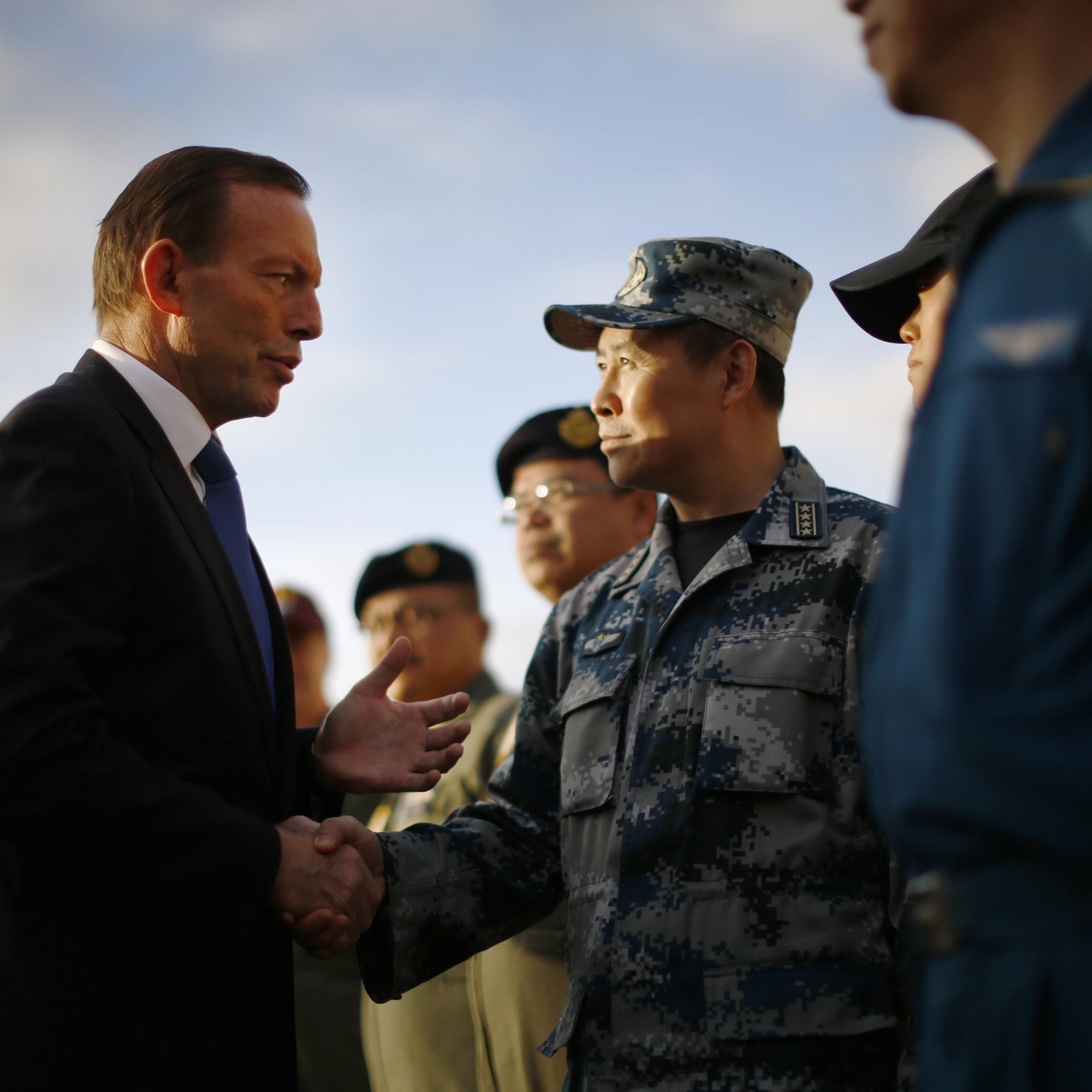 Australian Prime Minister Tony Abbott speaks with China's Air Force Senior Colonel Liu Dian Jun, head of China's effort to locate Malaysia Airlines flight MH370, during his visit to RAAF Base Pearce on March 31, 2014 in Perth, Australia.