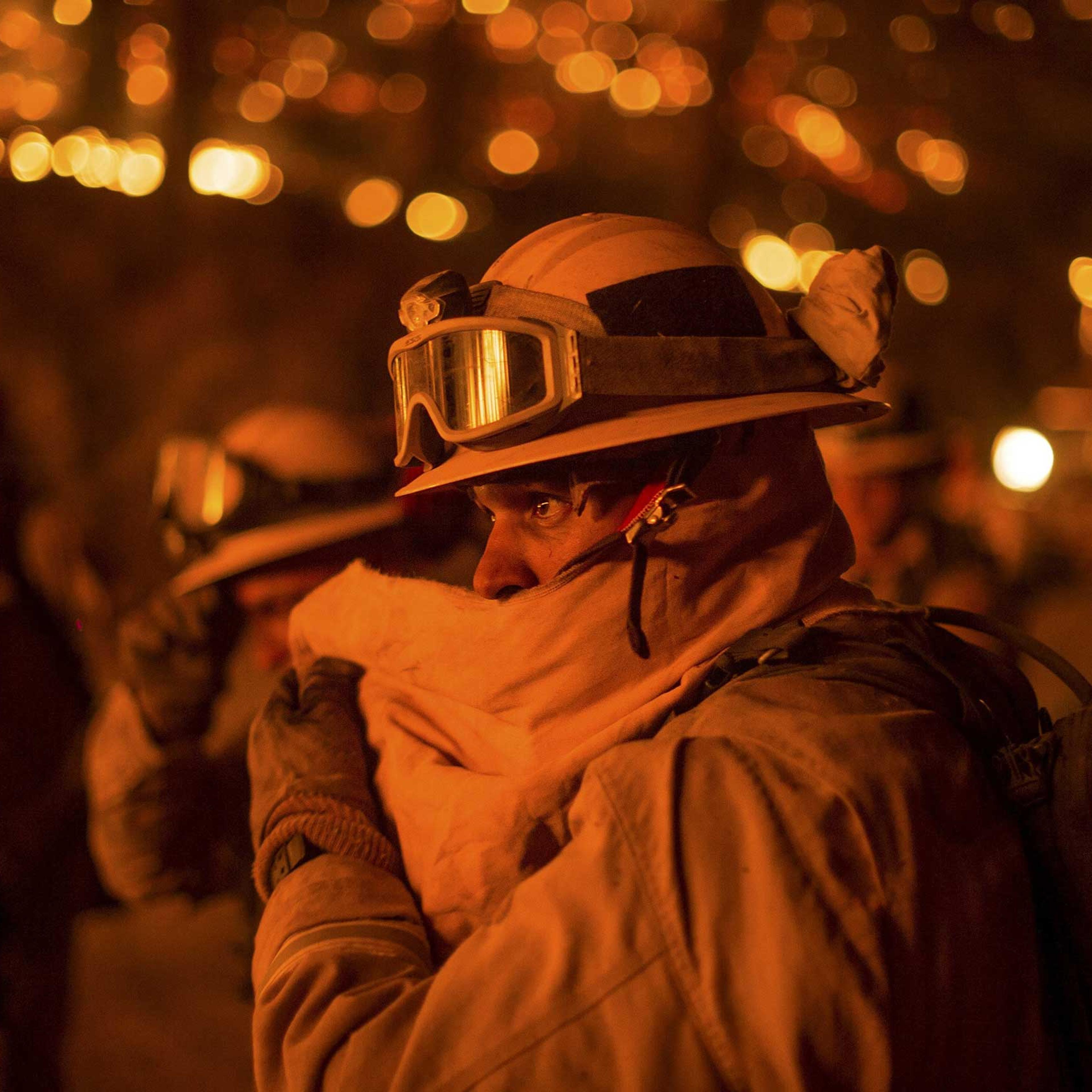 Firefighter covers his face while battling the Butte fire near San Andreas