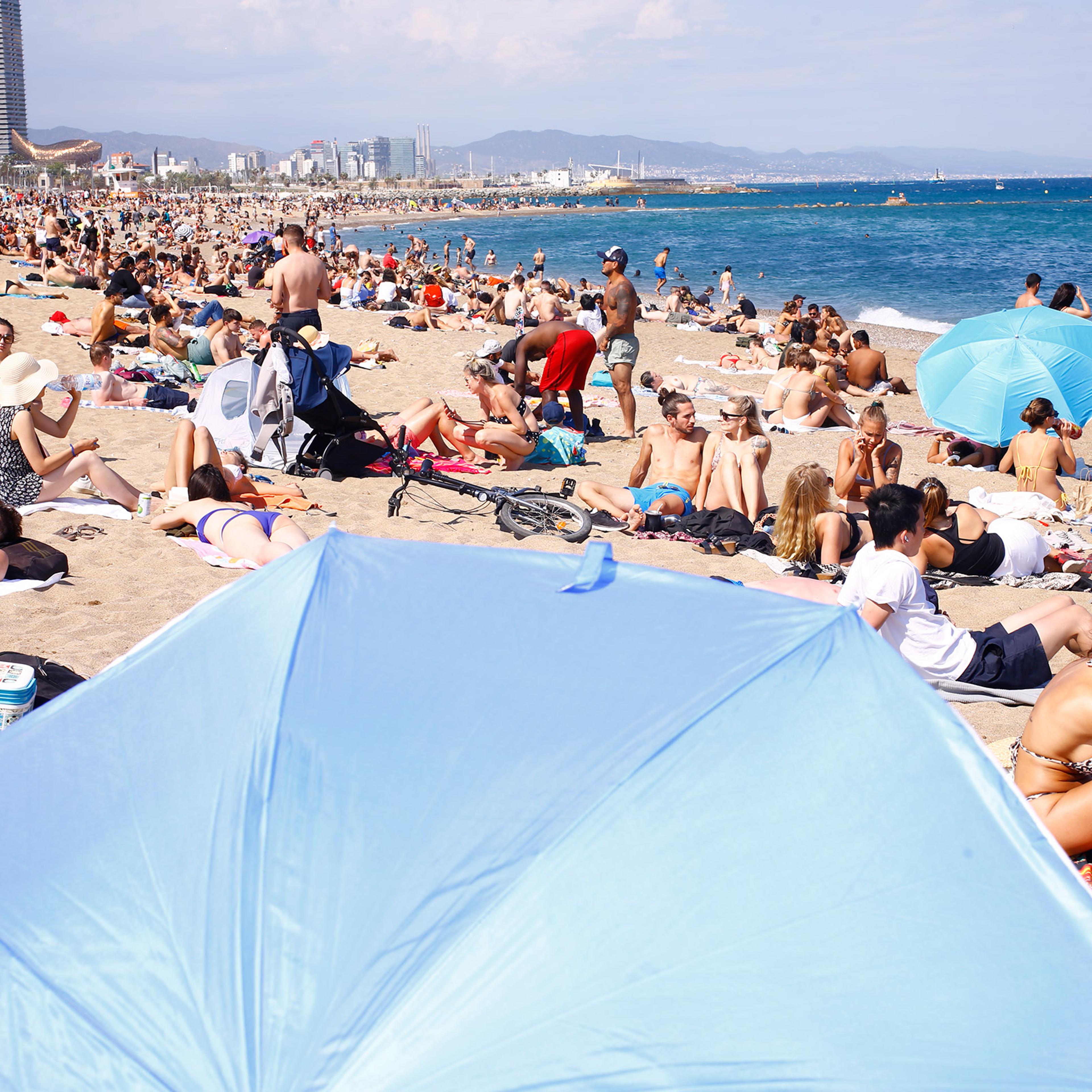 Sunbathers enjoy the busy Barceloneta Beach on June 6, 2021.