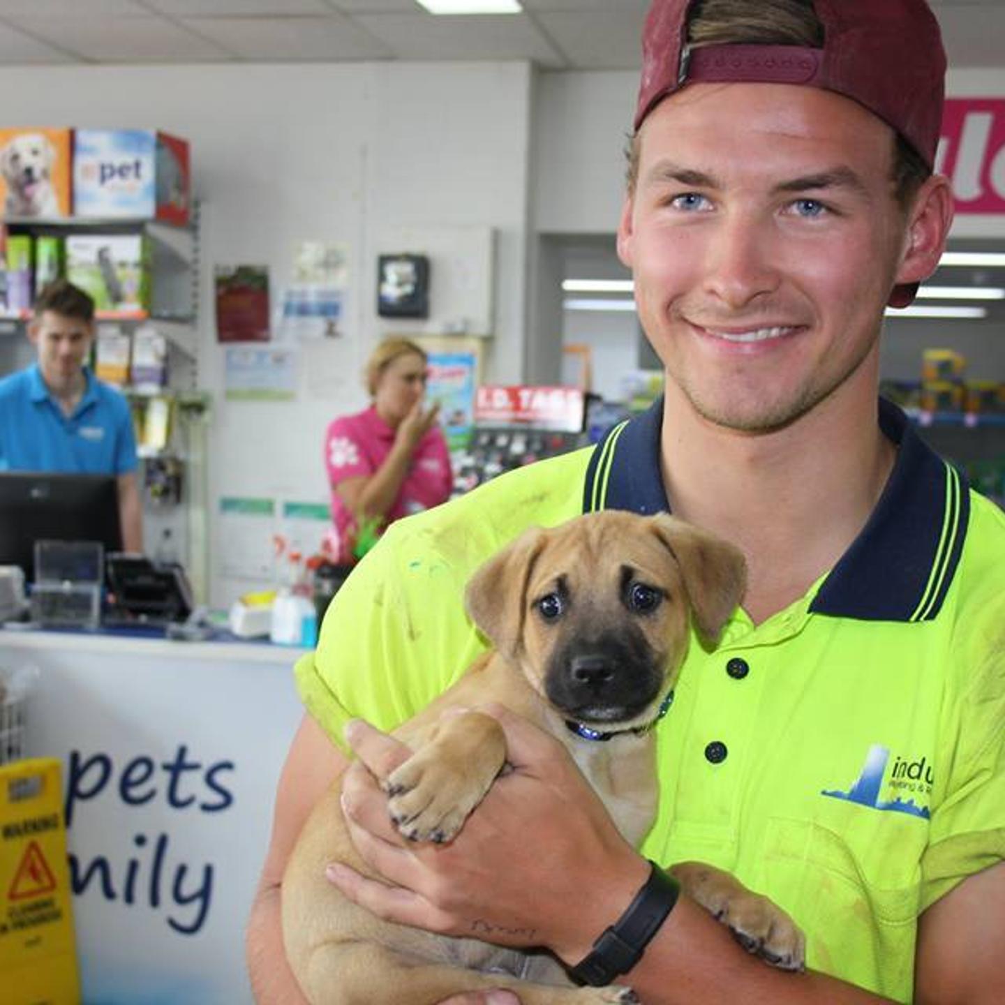 Ben Henderson and his adopted puppy Raffa at Pet's Haven Animal Shelter in Melbourne, Australia.