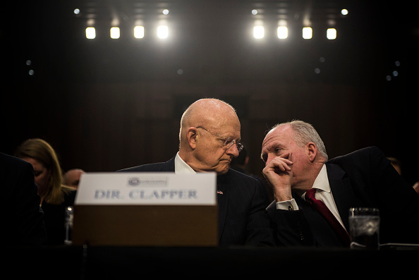 Director of National Intelligence James Clapper speaks to CIA Director John Brennan before the start of the Senate (Select) Intelligence Committee hearing at the Hart Senate Building on February 9, 2016 in Washington, D.C.