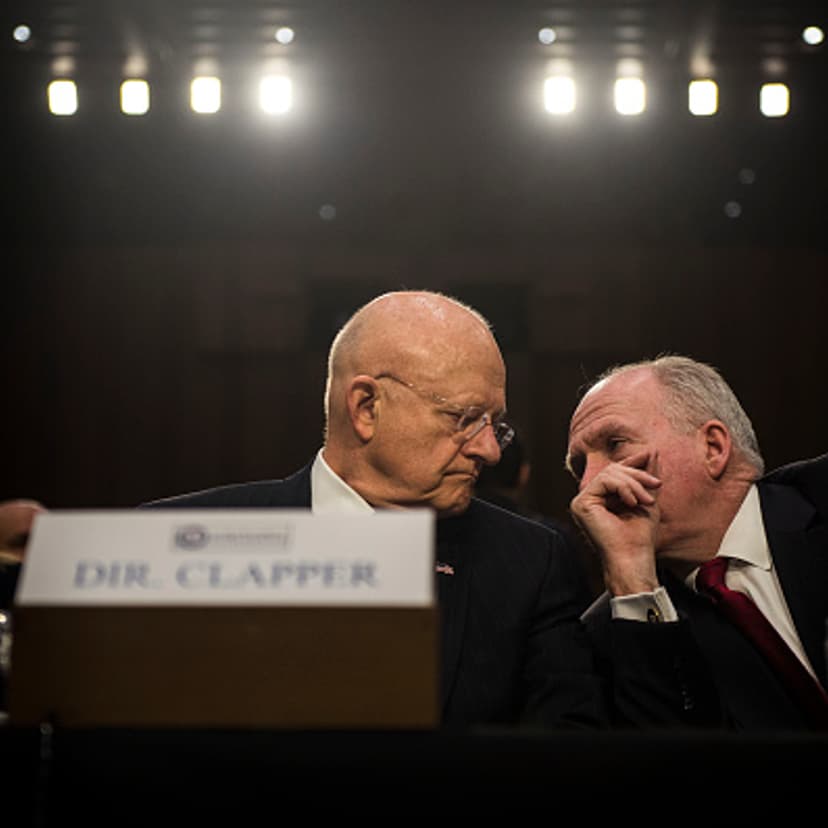 Director of National Intelligence James Clapper speaks to CIA Director John Brennan before the start of the Senate (Select) Intelligence Committee hearing at the Hart Senate Building on February 9, 2016 in Washington, D.C.