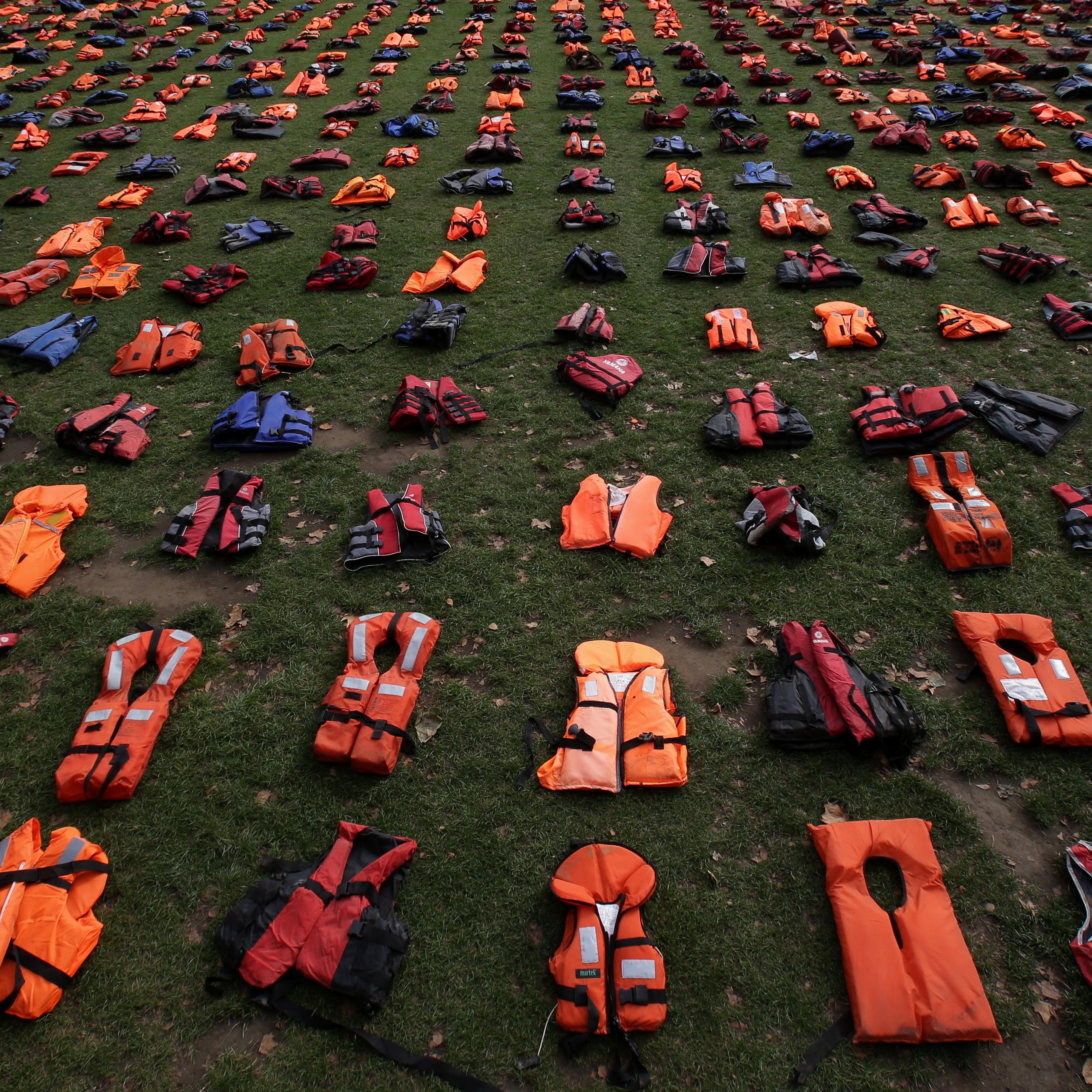 2,500 lifejackets, worn by refugees during crossings from Turkey to the Greek island of Chios, are displayed on Parliament Square, opposite the Houses of Parliament, in central London, on September 19, 2016, during a photcall to highlight the number of r