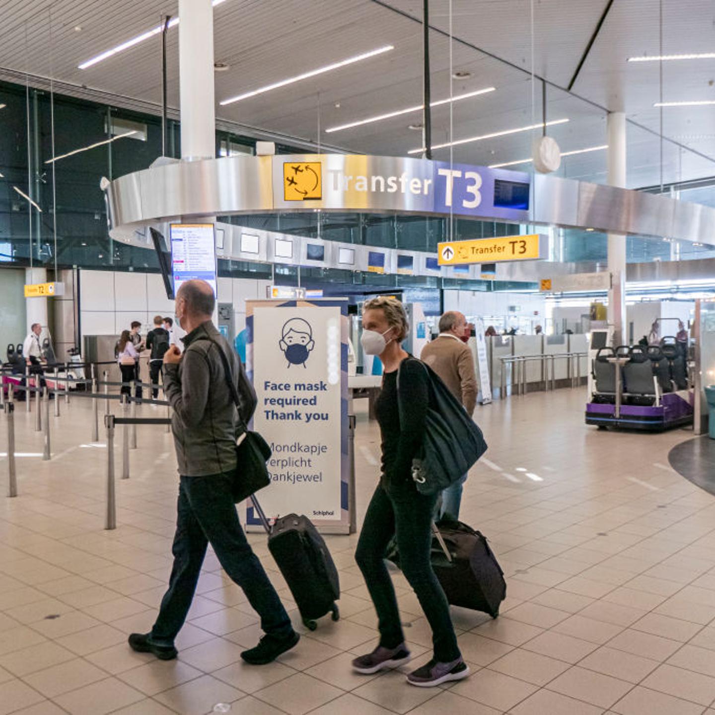 Passengers Wearing Face Masks In Amsterdam Schiphol Airport