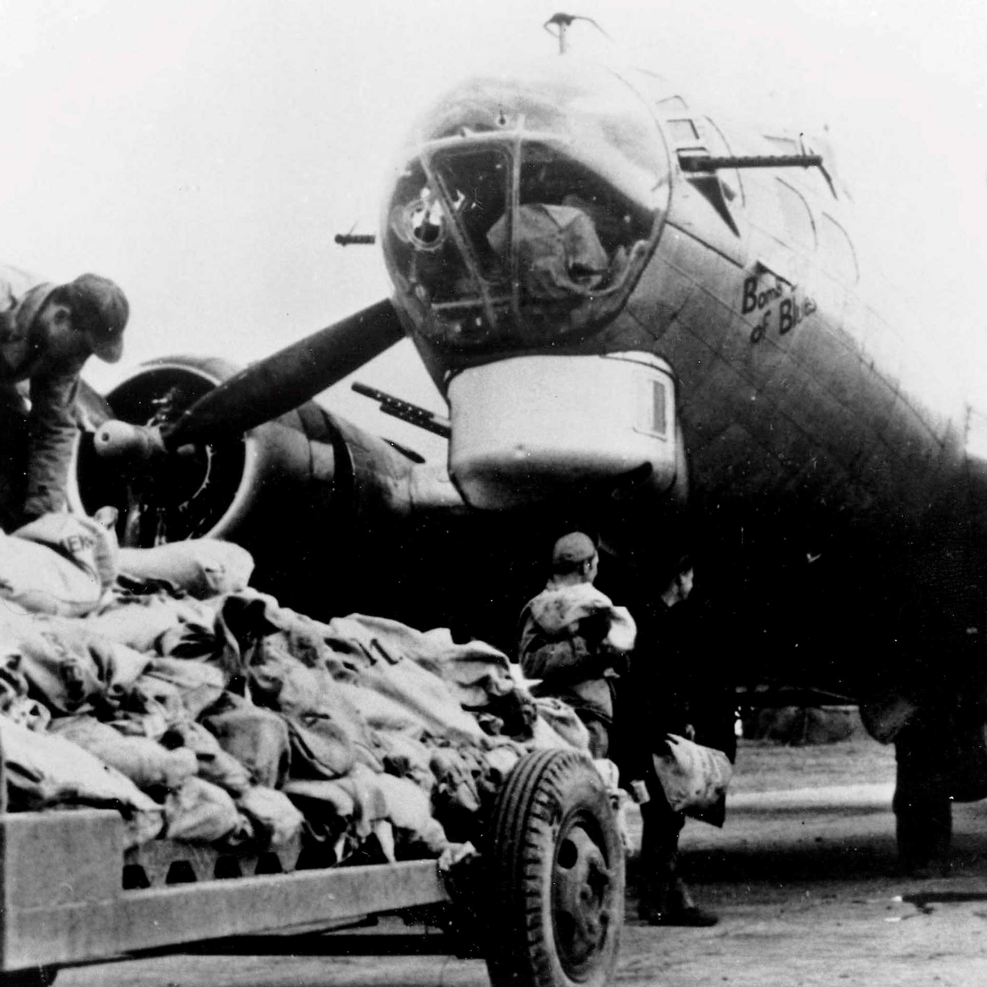 Workers load food onto an American B17 bomber during Operation Chowhound which involved dropping essential food supplies from bombers to the starving Dutch people at the end of WWII.